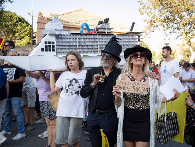 <p>Two people do a performance as they take part in a demonstration to protest against overtourism and housing prices on the island of Mallorca in Palma de Mallorca on July 21, 2024</p>