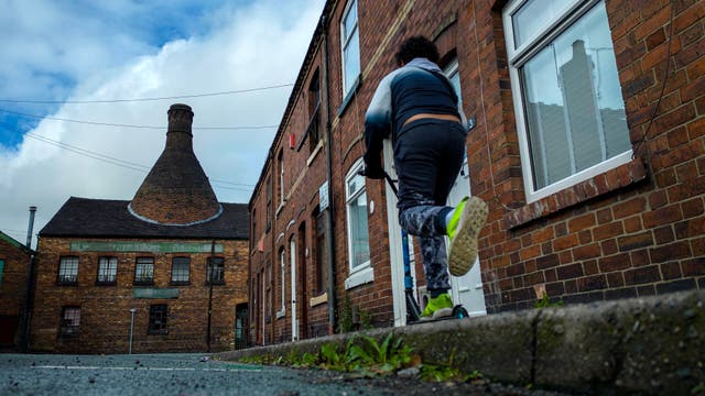 <p>A boy plays in the street near the Heron Cross pottery kiln on October 31, 2023 in Stoke on Trent, England Government figures show that Stoke on Trent has the second highest levels of fuel poverty in the country and a recent council report states that average wages in the city are 85 percent of the national figure.</p>