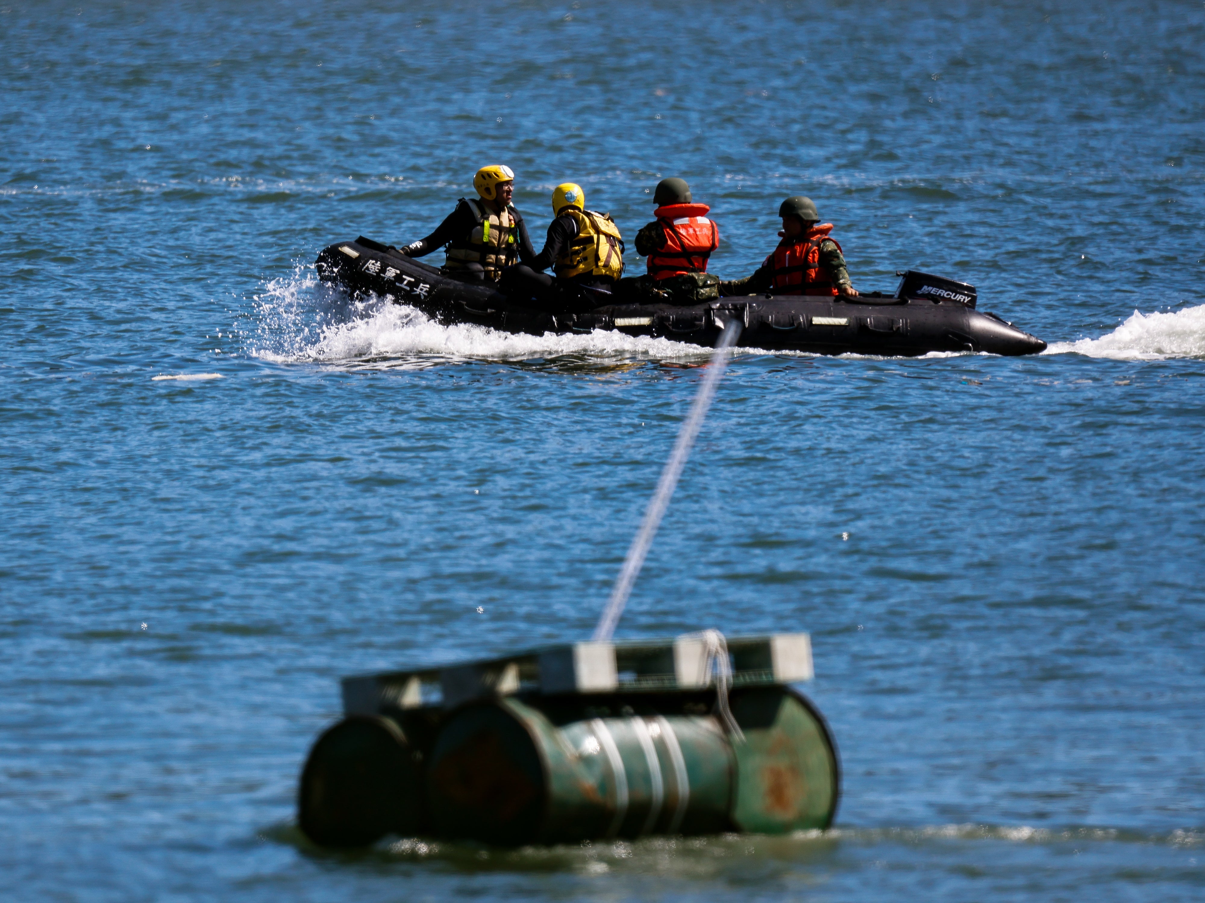 An oil drum is deployed as a blockade as soldiers on board a rubber boat patrol the Tamsui River, during a river defence exercise as part of the annual Han Kuang military drill, at Tamsui River in New Taipei, Taiwan on July 22, 2024