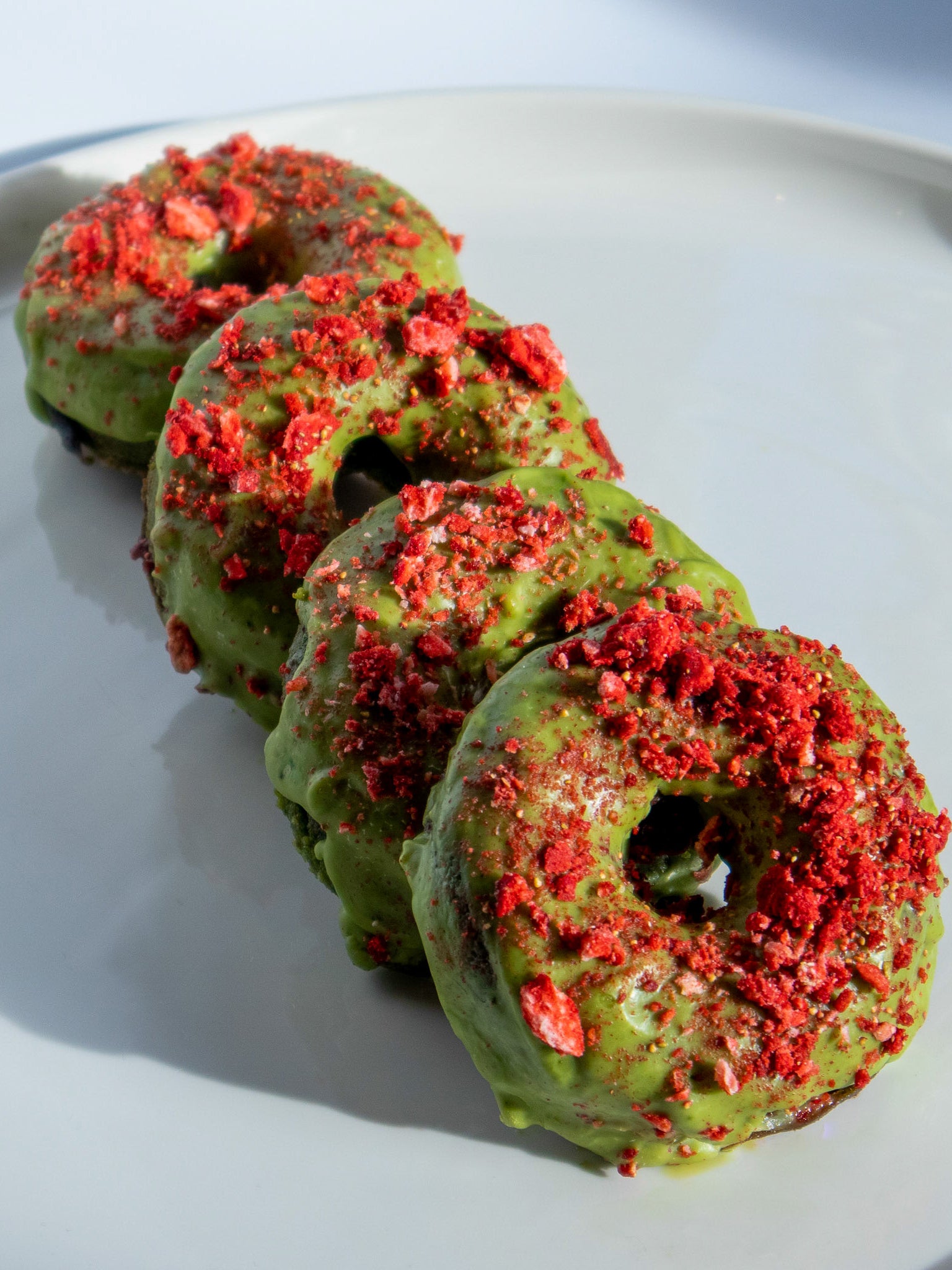 Golden, light vegan doughnuts with a vibrant green matcha kick, perfect for a sweet morning treat or afternoon snack