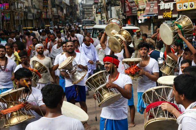 <p>Hindus take part in a procession to celebrate a festival dedicated to god Shiva in the northern city of Varanasi</p>