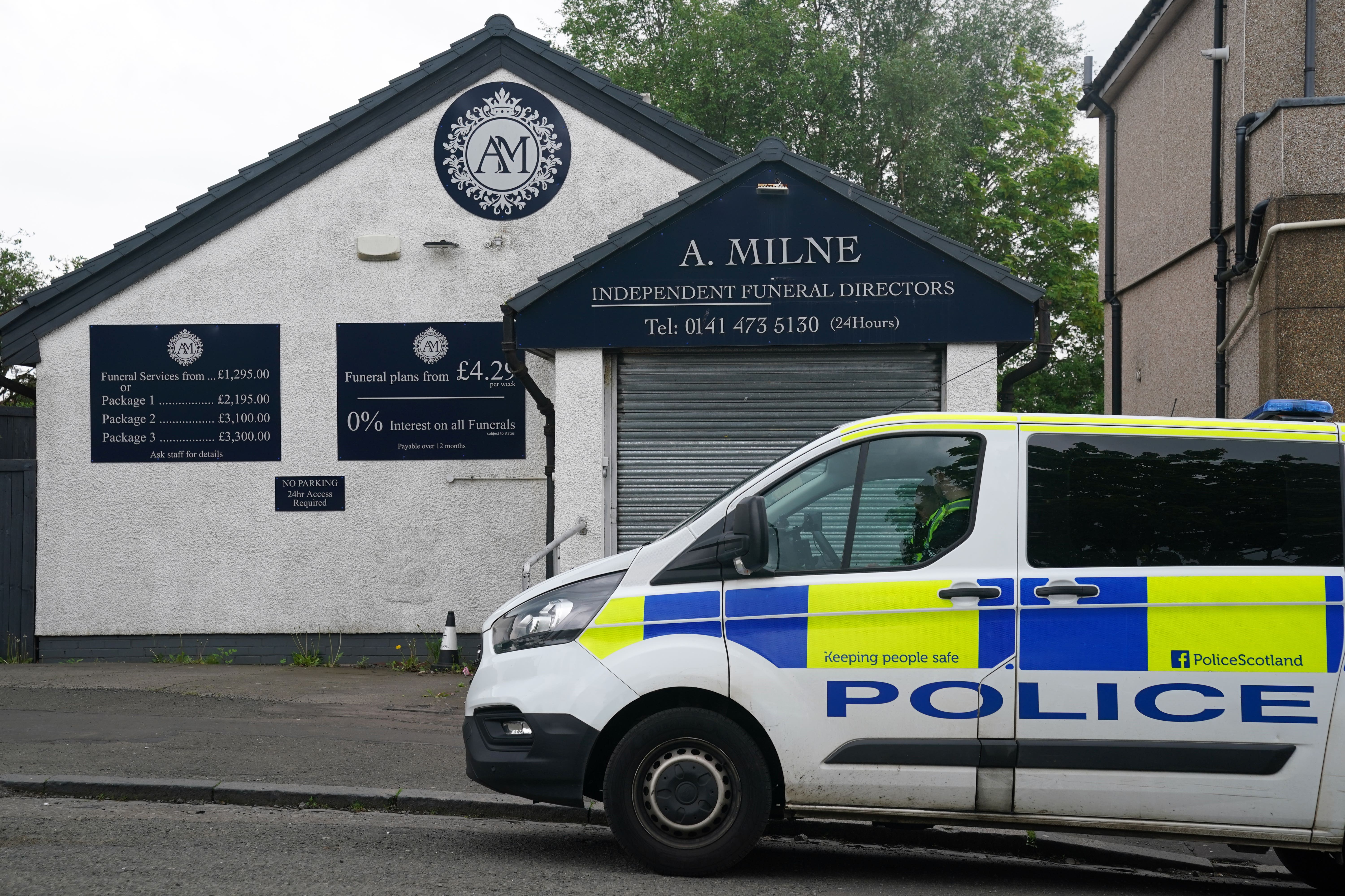 A police vehicle outside A Milne Funeral Directors in Balornock, Glasgow (Andrew Milligan/PA)