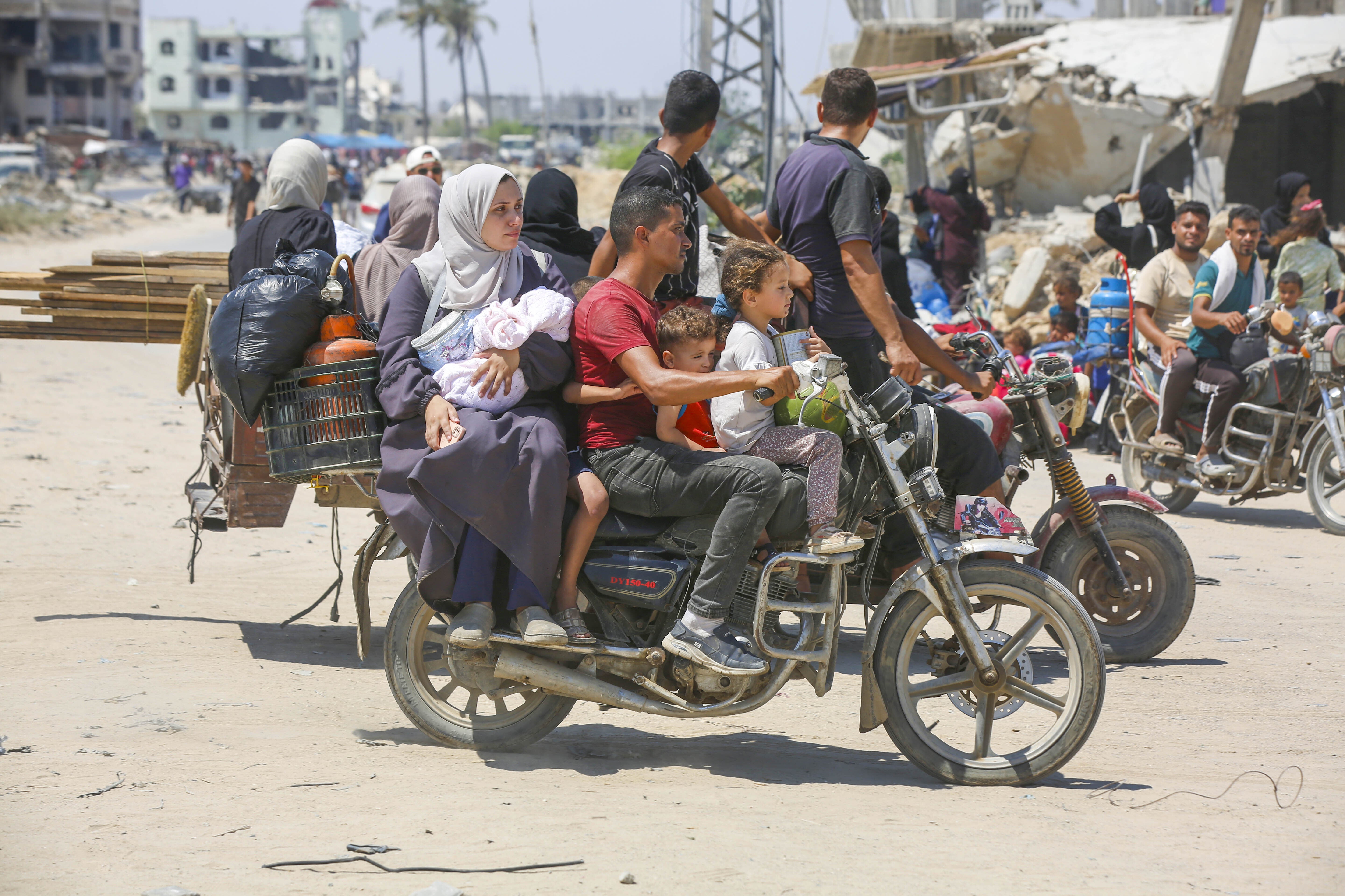 Palestinians, including women and children, who live in the eastern part of the city of Khan Younis moved to a safe area with whatever belongings they could take.