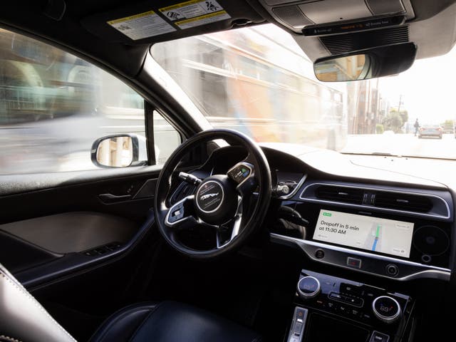 <p>A driverless Waymo car drives through the streets of San Francisco in November 2023</p>