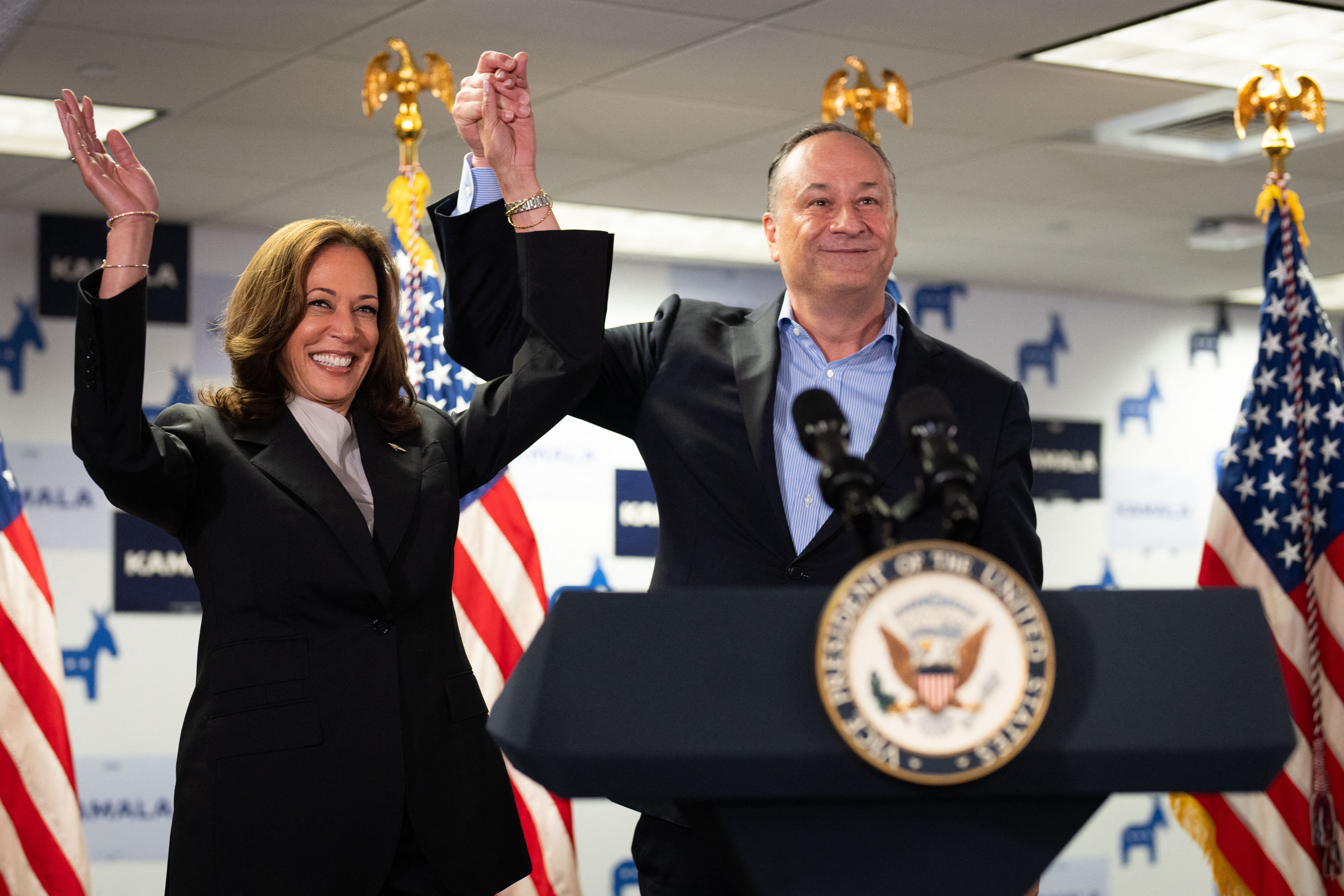 US vice president and Democratic presidential candidate Kamala Harris and Second Gentleman Doug Emhoff acknowledge the crowd before speaking at her campaign headquarters in Wilmington, Delaware, on 22 July 2024