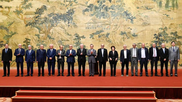 <p>China’s foreign minister Wang Yi (C) poses for a group picture with members of the Palestinian factions during the signing of the ‘Beijing declaration’ at the Diaoyutai State Guesthouse in Beijing</p>