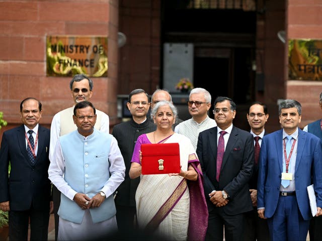 <p>India’s finance minister Nirmala Sitharaman poses for photos before presenting the budget in the parliament on 23 July 2024</p>