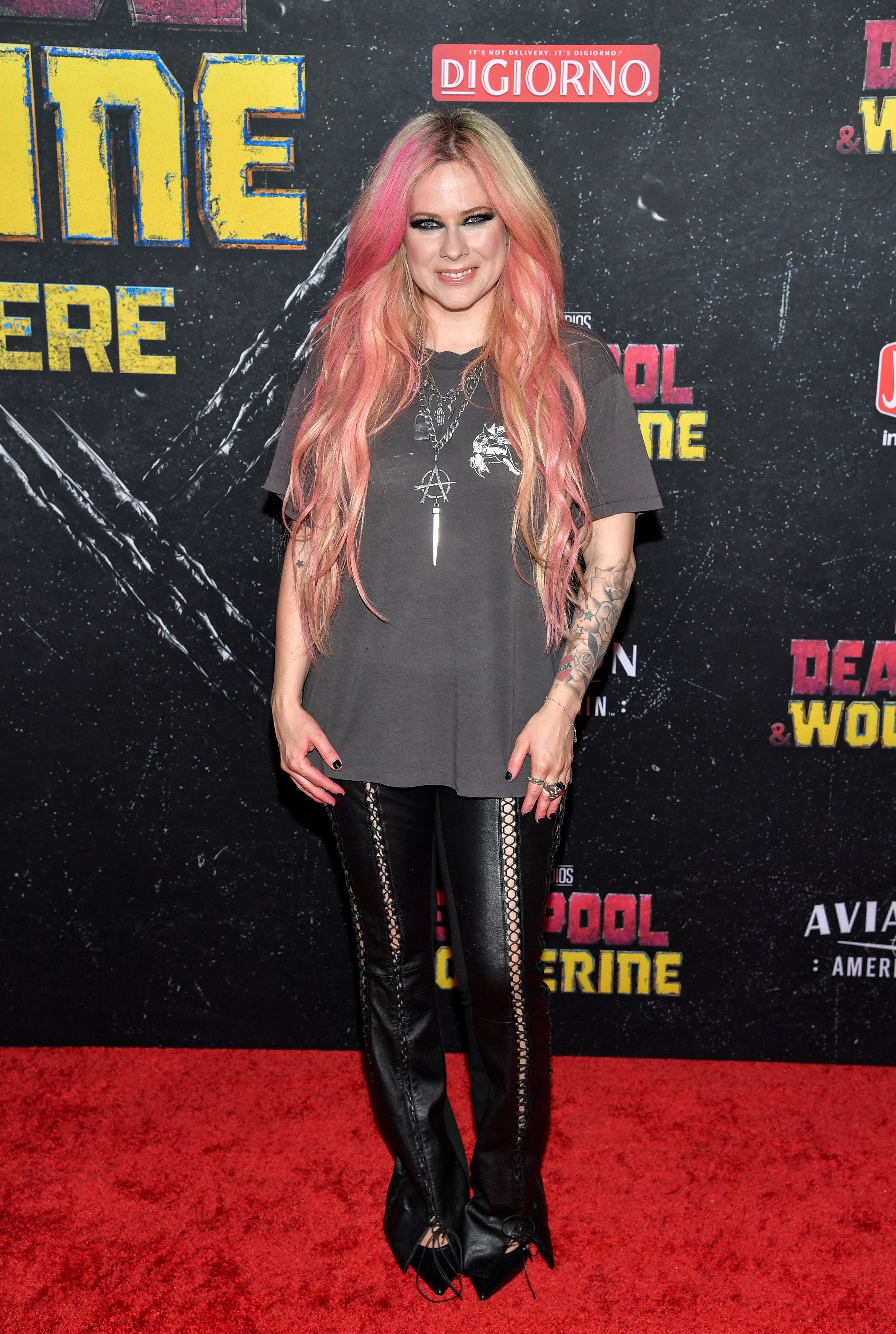 Avril Lavigne invoked her pop-punk roots with heavy kohl liner and silver chain accessories (AP/PA)