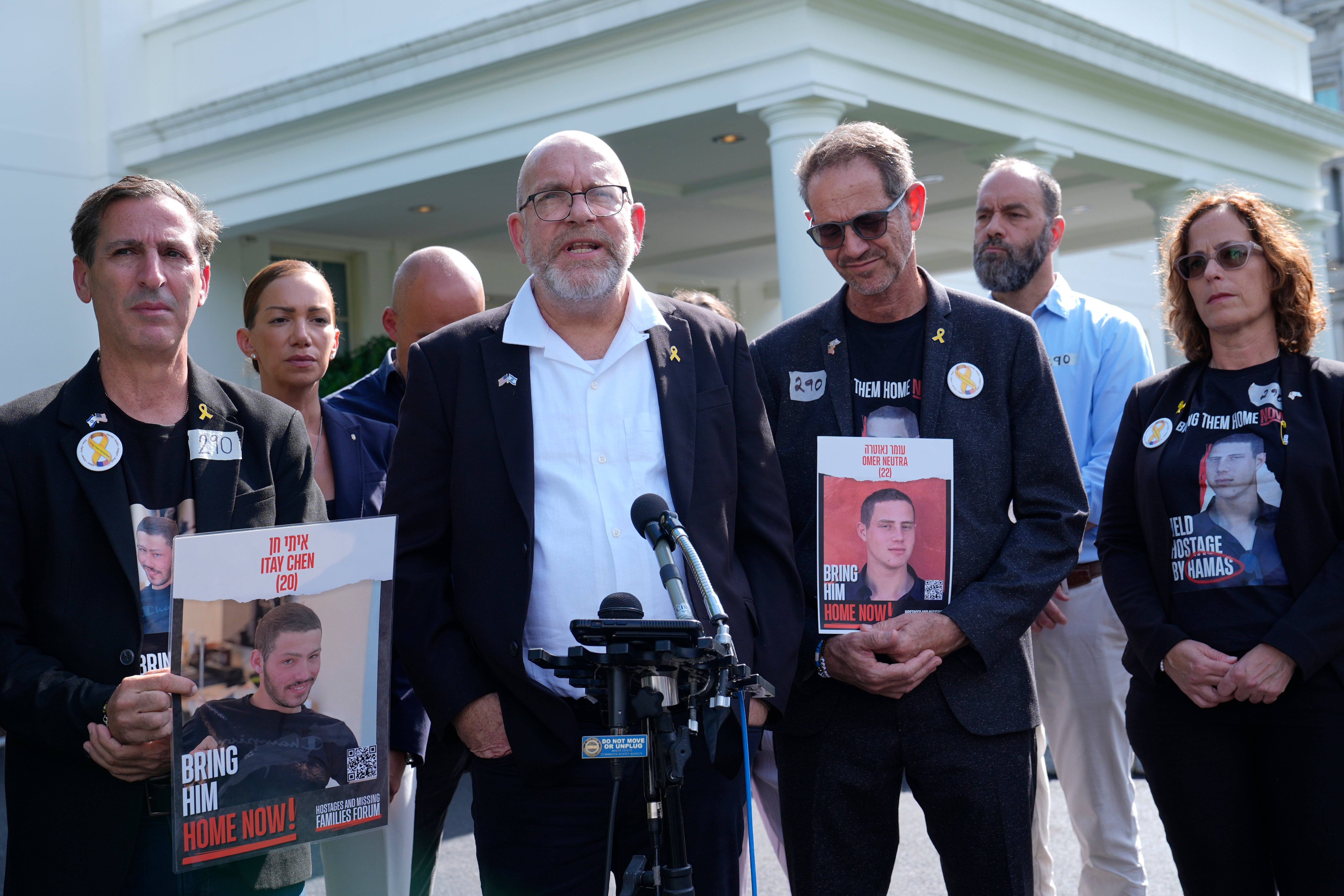 Jonathan Dekel-Chen (center, white shirt) is uncertain about the fate of his son, Hamas hostage Sagui Dekel-Chen, despite recently announced ceasefire deal