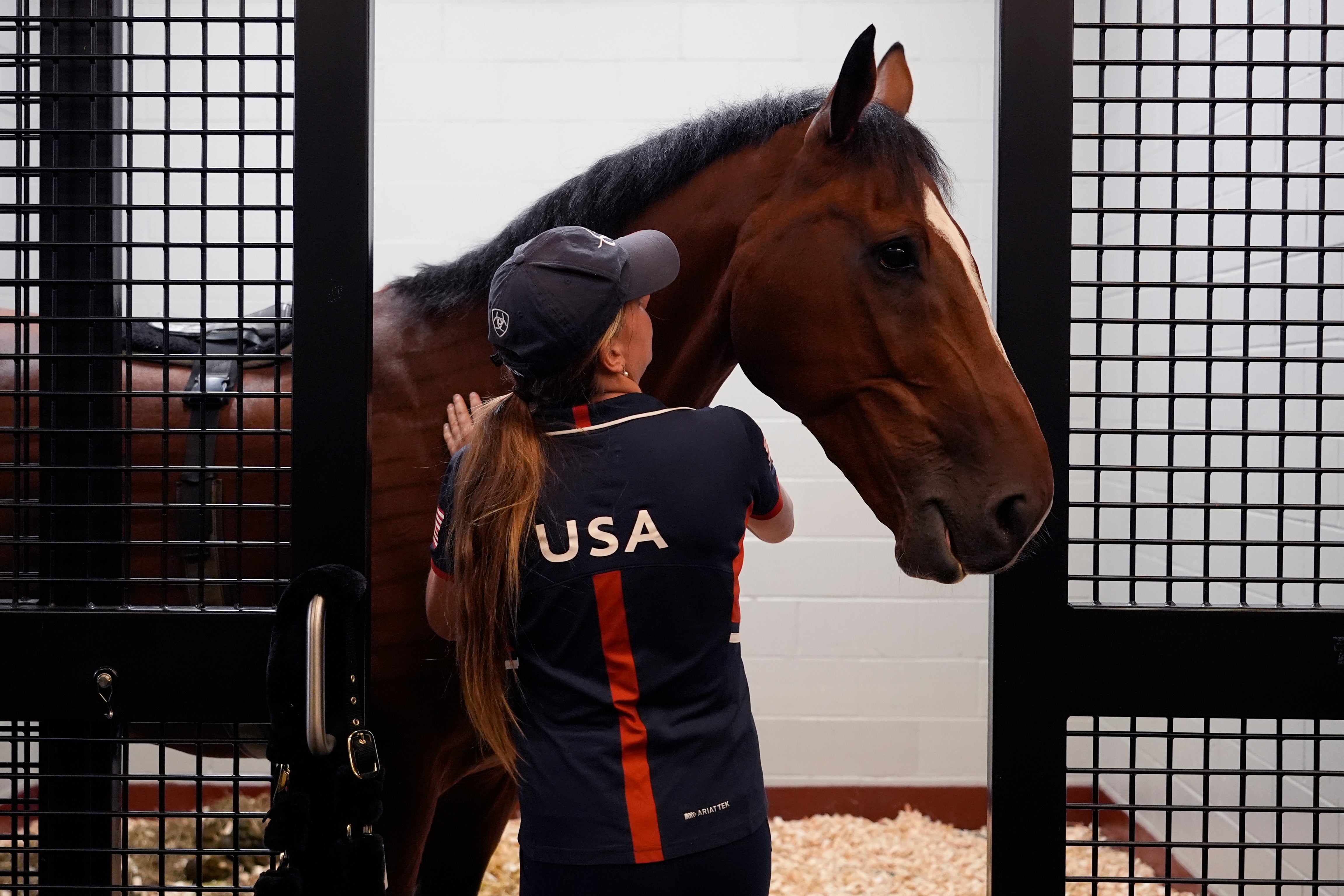 Hailey Burlock, groom for U.S. Olympic Eventing Team member Will Coleman, comforts Off The Record ahead of the journey to Paris