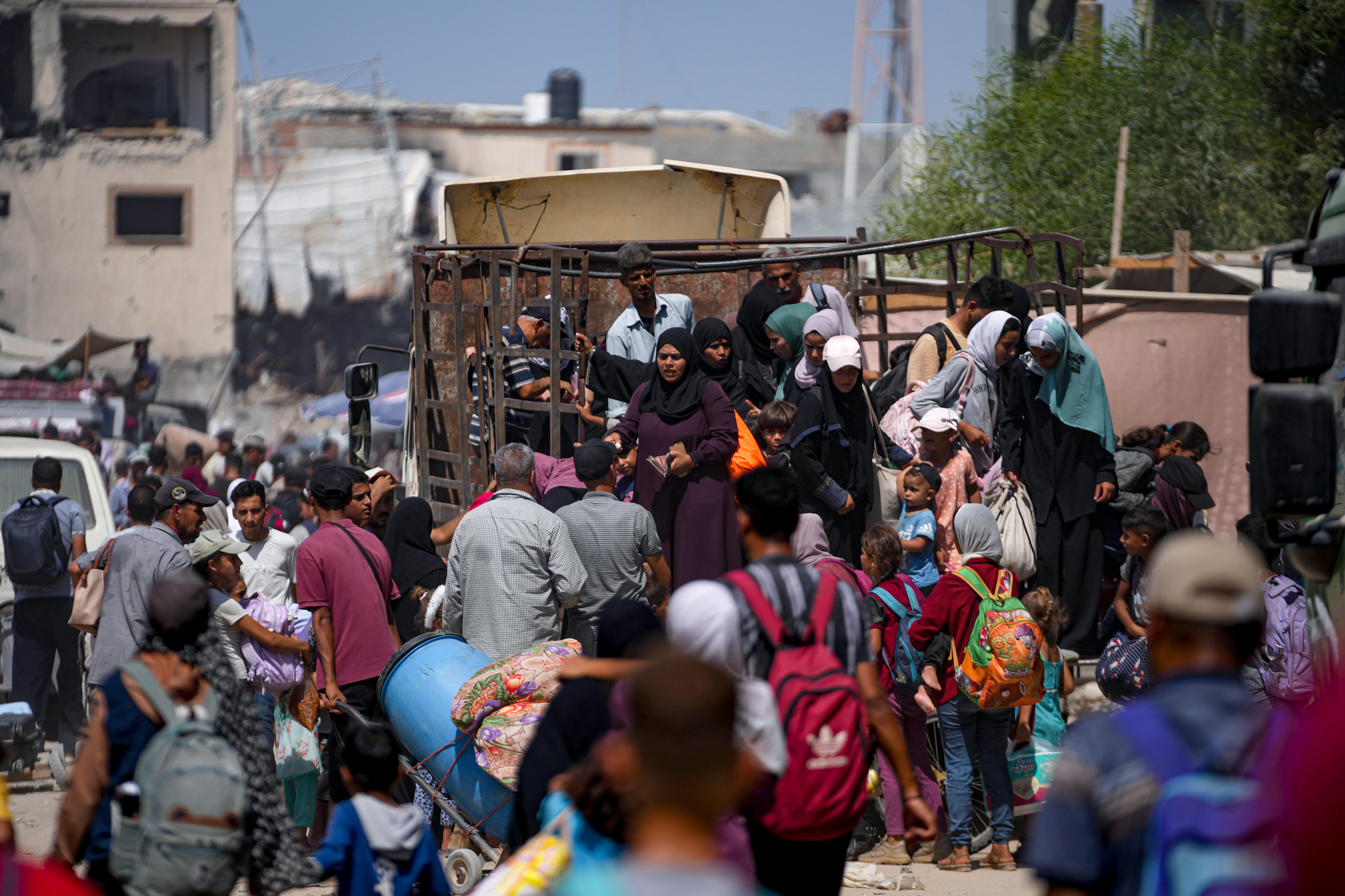 Palestinians displaced by the Israeli air and ground offensive on the Gaza Strip flee