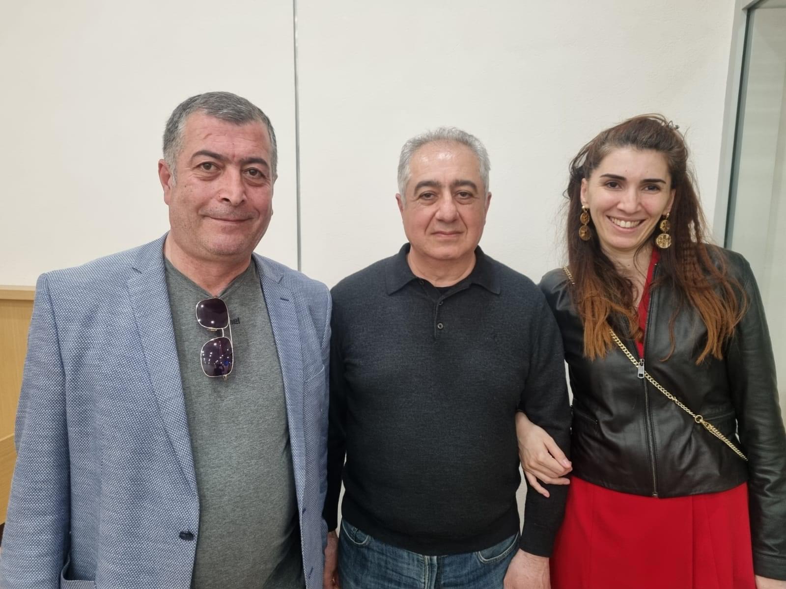 Gubad Ibadoghlu (centre) with his two lawyers after being released into house arrest earlier this year