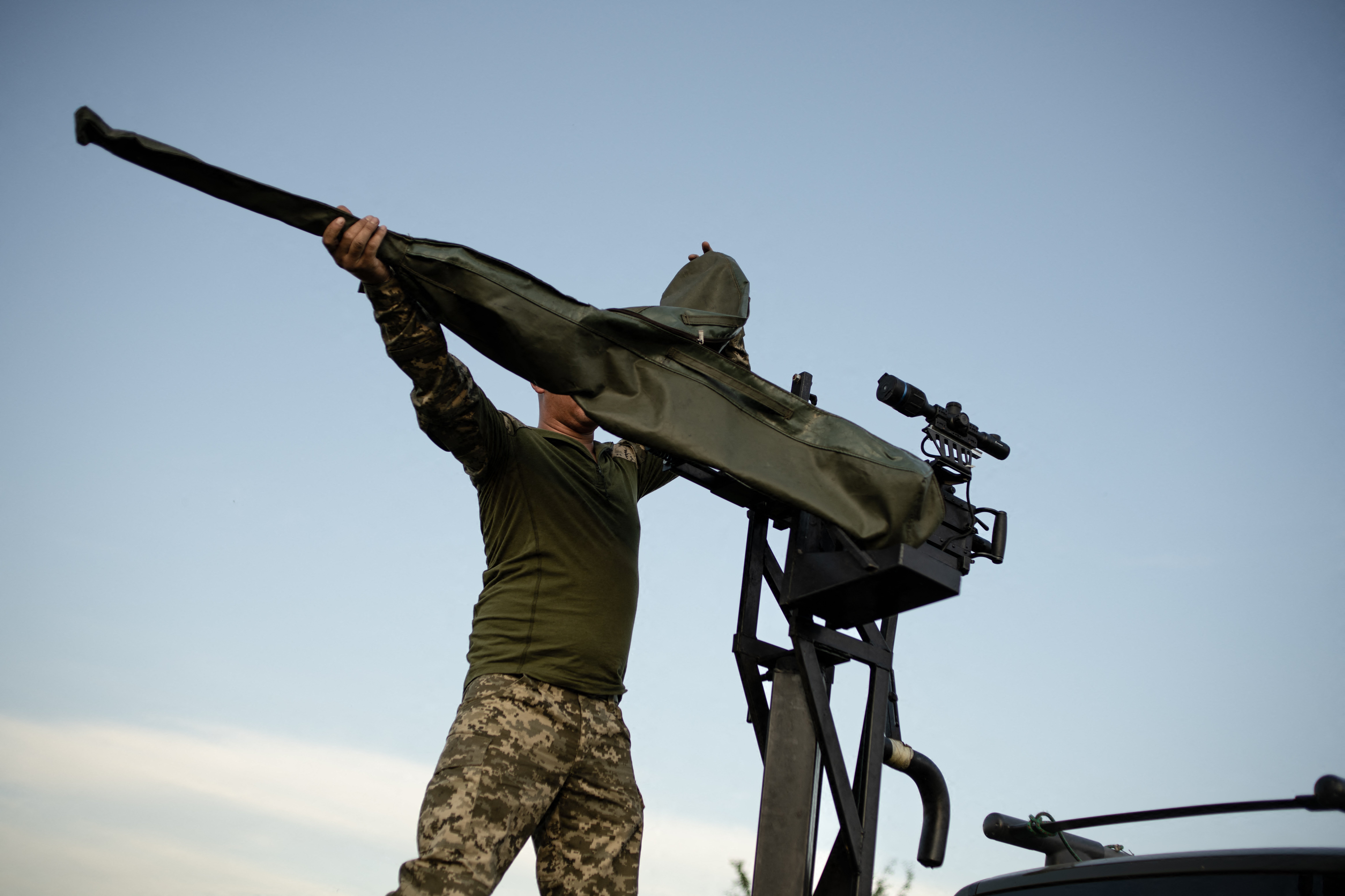 A soldier from the mobile air defense brigade prepares a 12.7mm heavy machine gun near a training ground in the Khmelnitsky region.