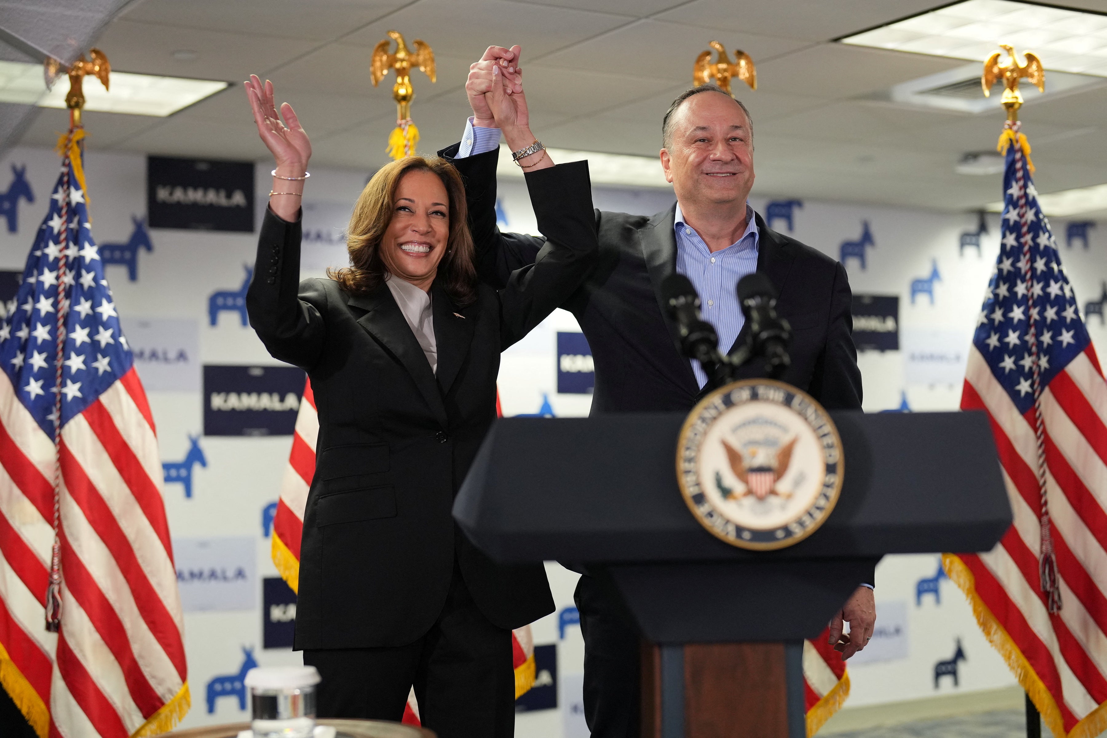 Harris and her partner Douglas Emhoff arrive at her presidential campaign headquarters in Wilmington