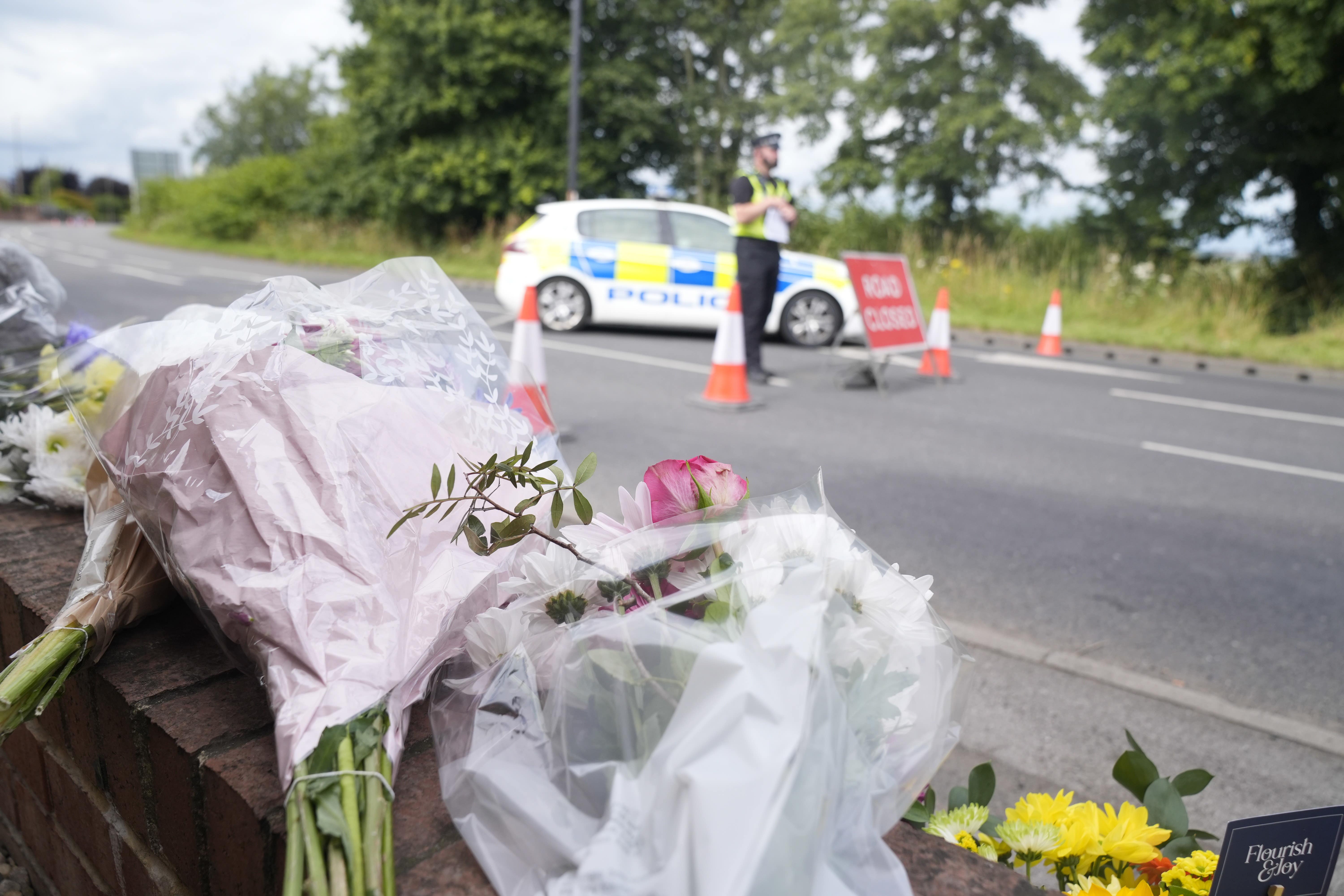 Flowers and tributes laid near the scene on the A61 in Wakefield (Danny Lawson/PA)