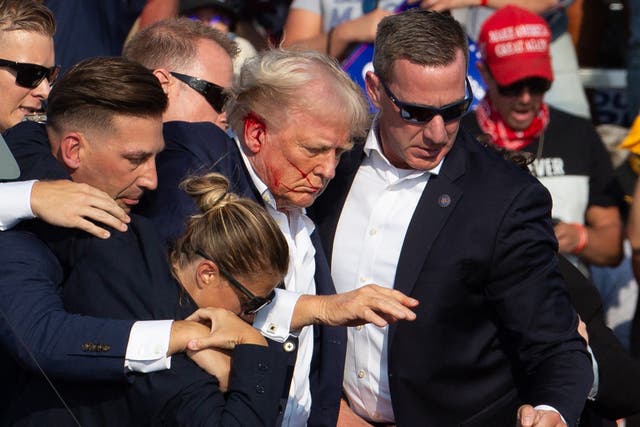 <p>Secret Service agents surround Donald Trump after shots were fired at a campagin rally in Pennsylvania on July 13. The former president is now blaming Joe Biden and Kamala Harris for ‘not properly’ protecting him. </p>