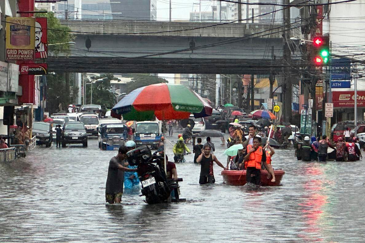 Streets flood from monsoon rains worsened by offshore typhoon Gaemi