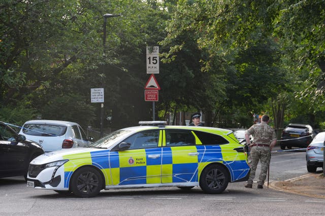 A man in military uniform stands beside a police cordon at the scene in Sally Port Gardens in Gillingham, Kent (Gareth Fuller/PA)