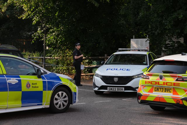 Police vehicles beside a cordon at the scene in Sally Port Gardens in Gillingham, Kent, after a soldier in uniform was stabbed on Tuesday evening. (Gareth Fuller/PA)