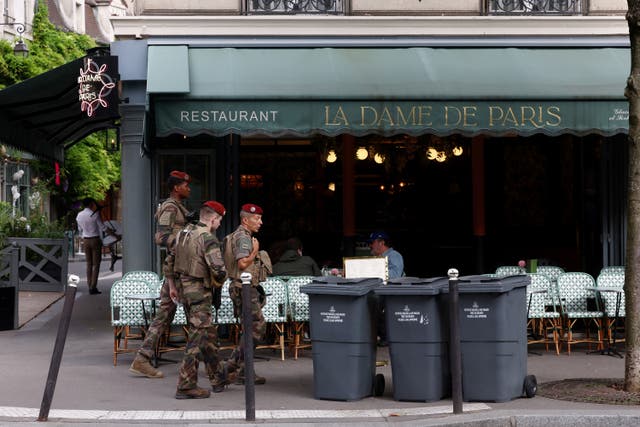 <p>Security forces personnel patrol ahead of the 2024 Olympics in Paris on July 23 2024</p>