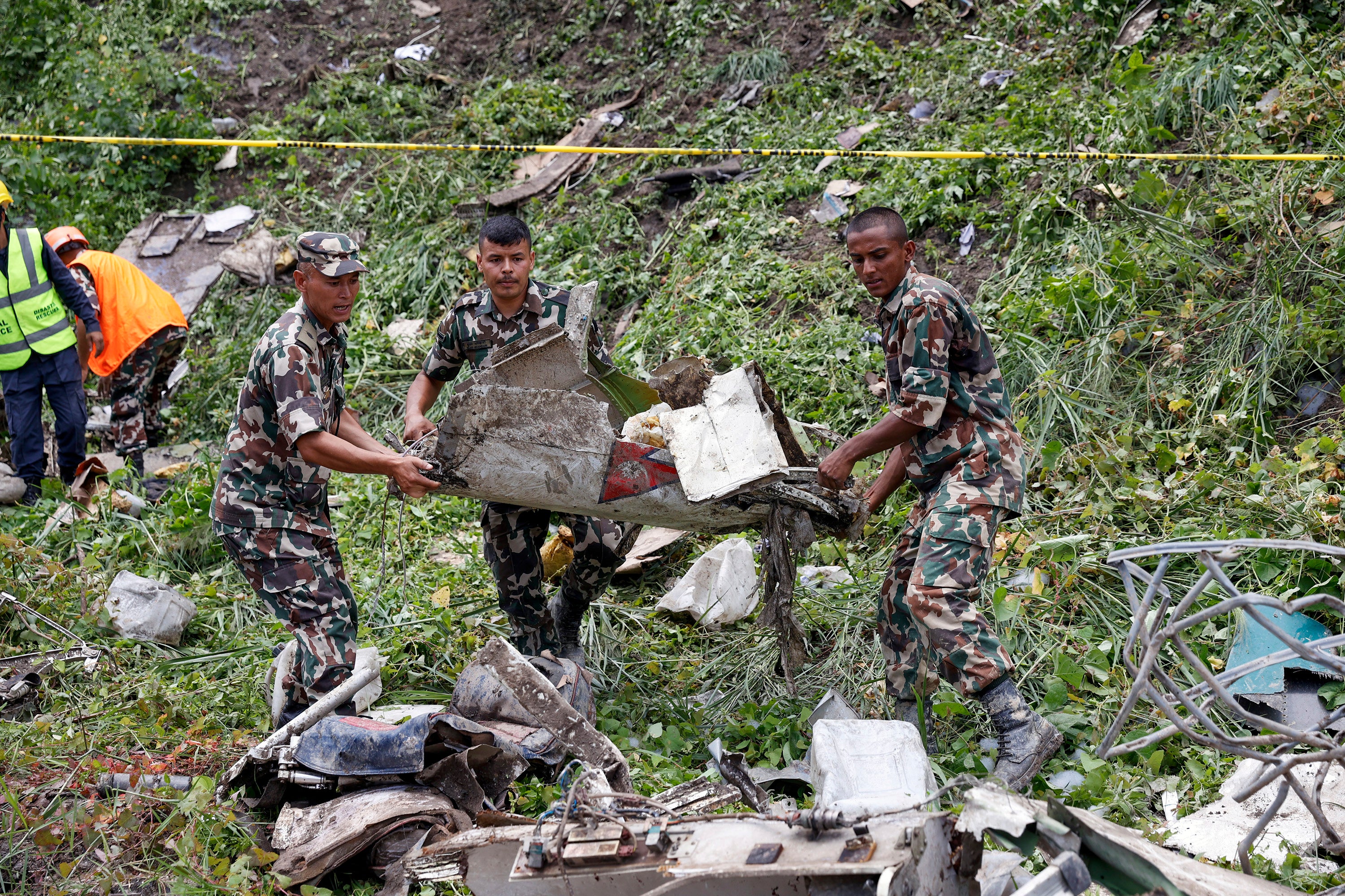 Nepalese army personnel sort debris after the crash