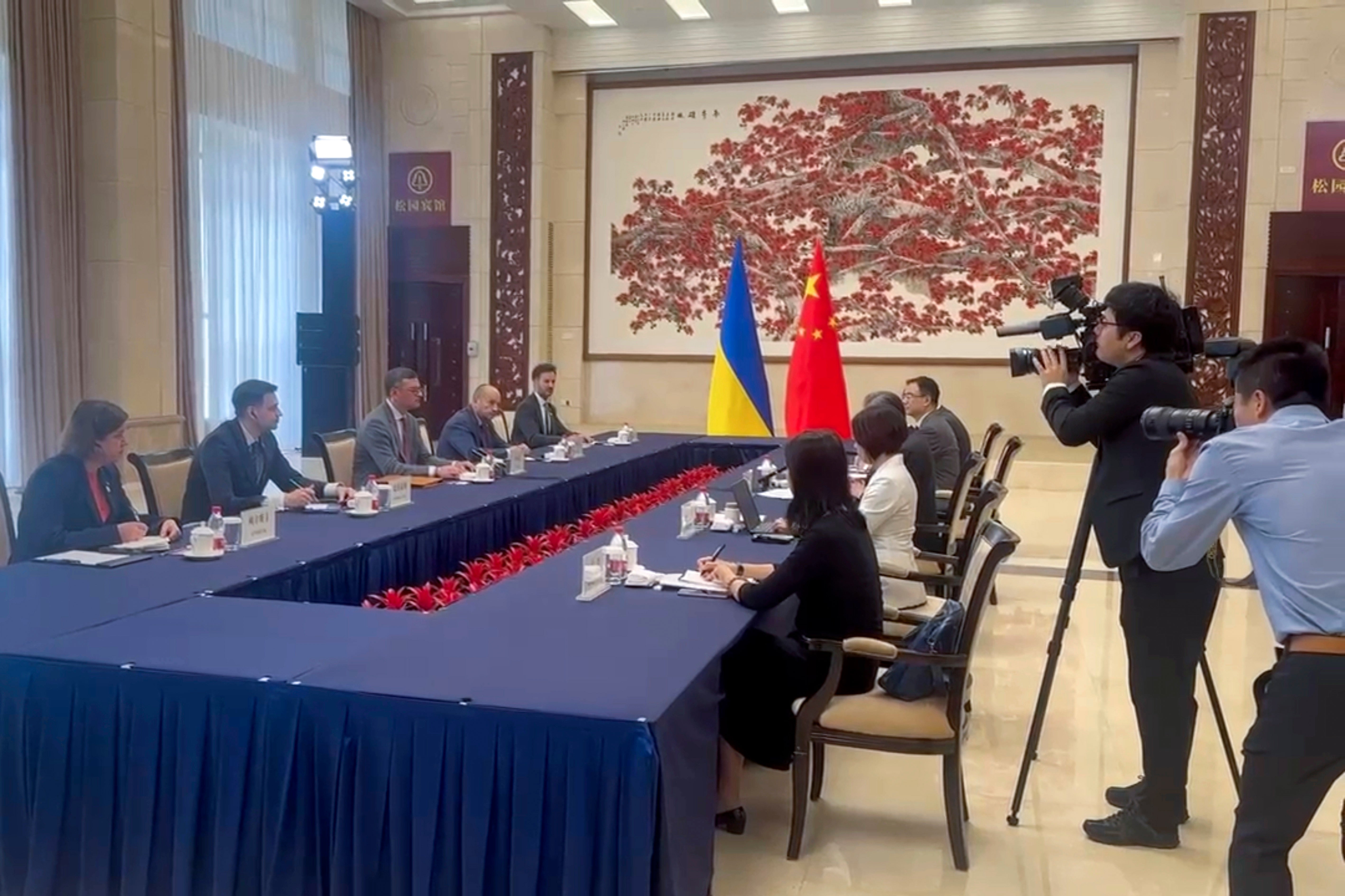 In this image taken from video released by the Ukraine Ministry of Foreign Affairs, Ukraine's Foreign Ministry Dmytro Kuleba, third from left holds talks with China's Foreign Minister Wang Yi at a meeting in the southern Chinese city of Guangzhou