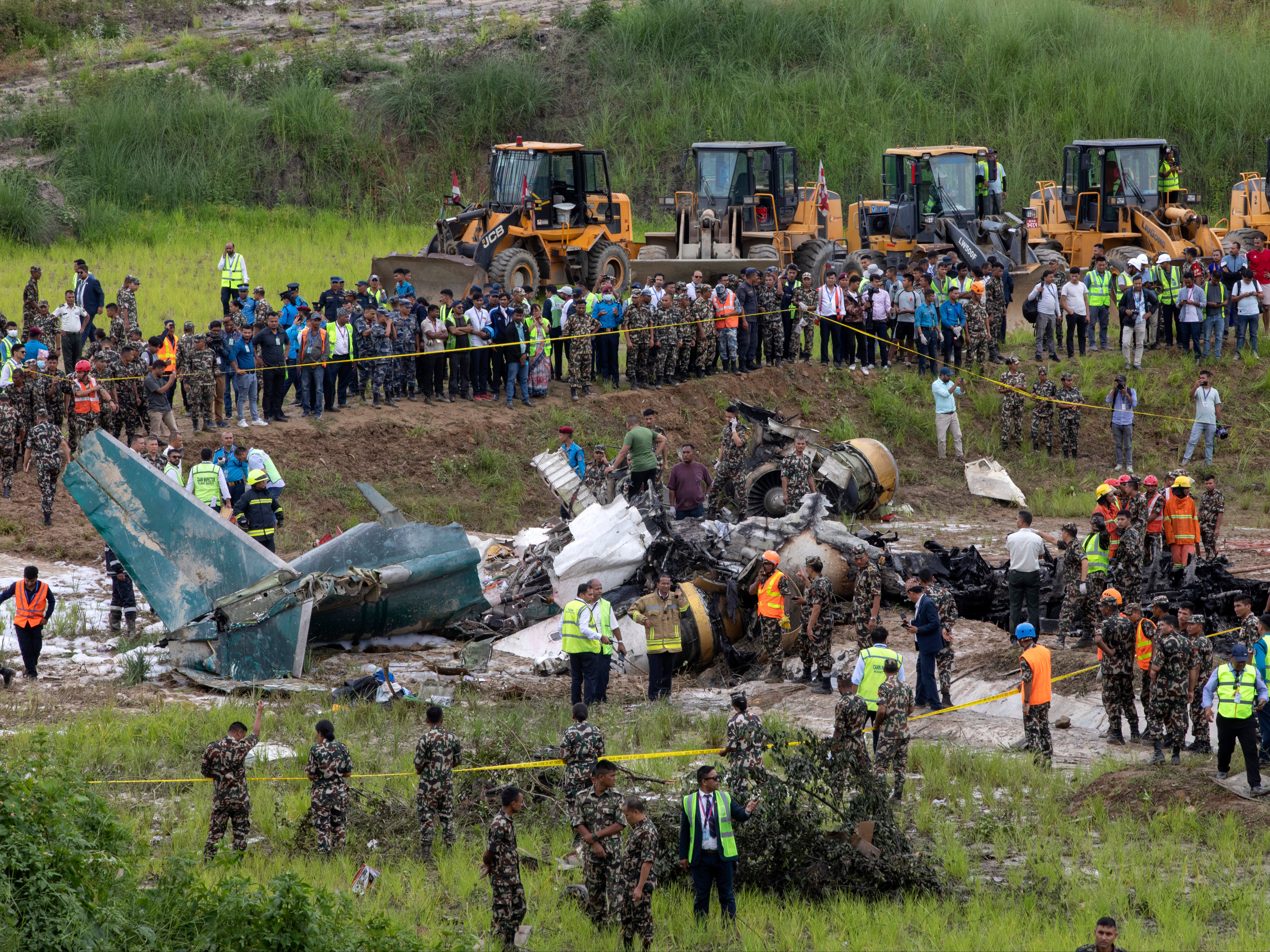 Rescue workers at the site of the plane crash at Kathmandu airport on 24 July 2024