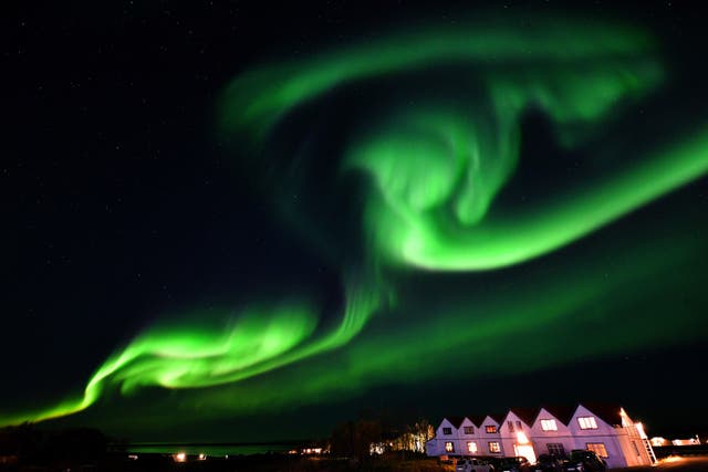 <p>The northern lights, also known as the aurora borealis, illuminate the sky in southeastern Iceland on 7 October, 2018</p>