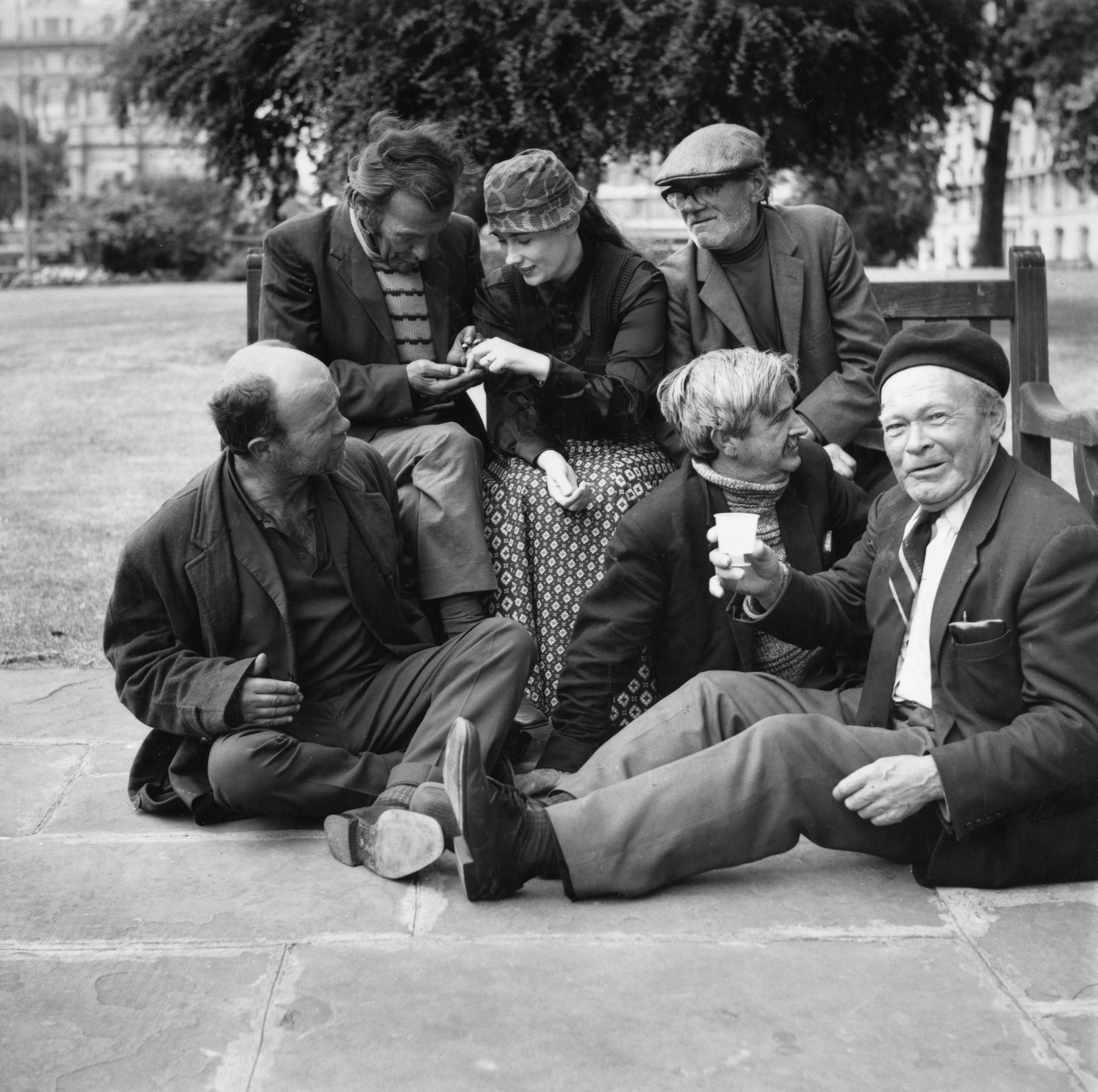 A group of homeless men and Peralta sitting at Marble Arch