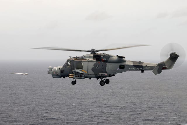 A Royal Navy Wildcat helicopter fires a lightweight multirole missile from the Martlet missile system during the Carrier Strike Group deployment of 2021 (MoD/PA)