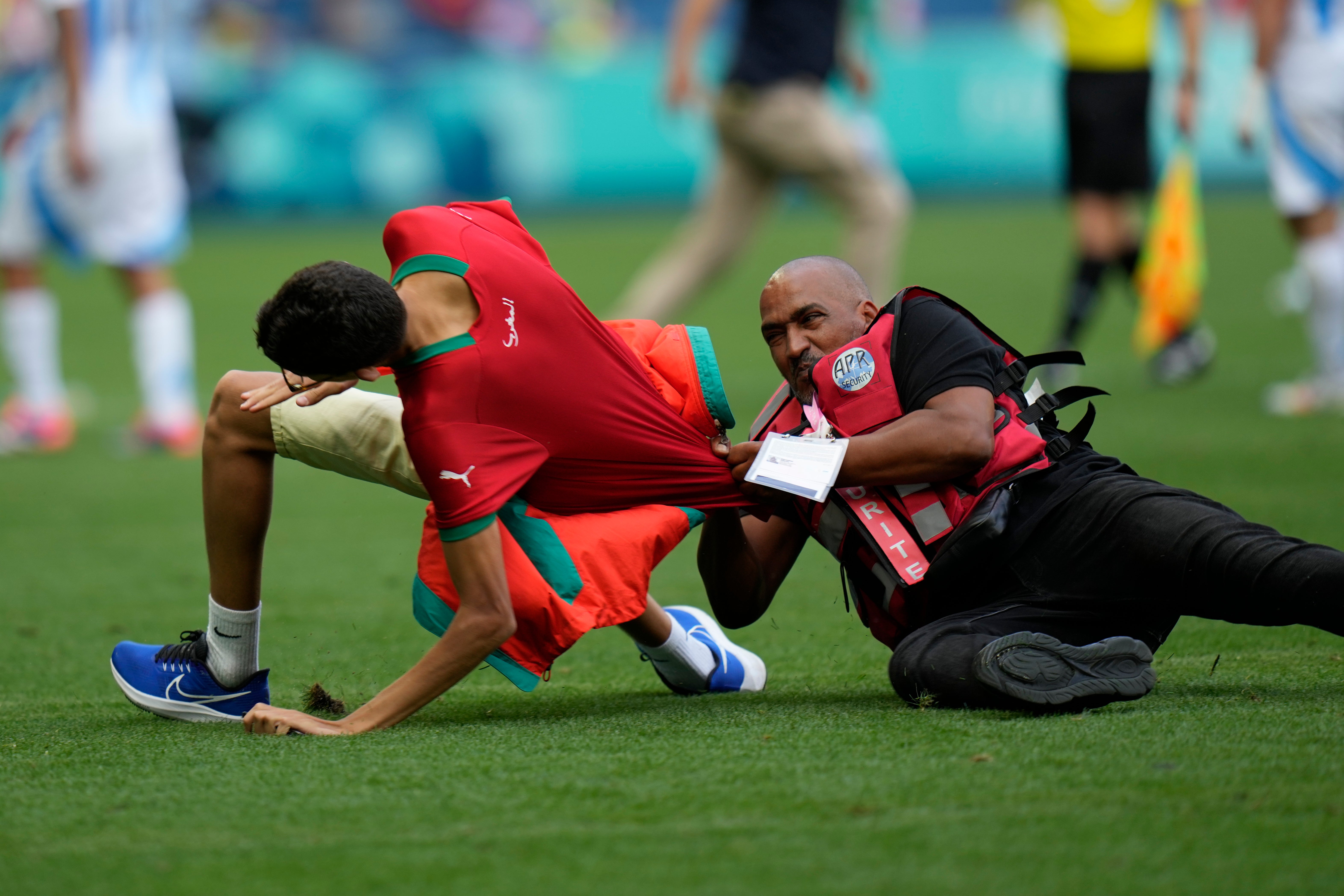 Fans invaded the pitch and were tackled by security