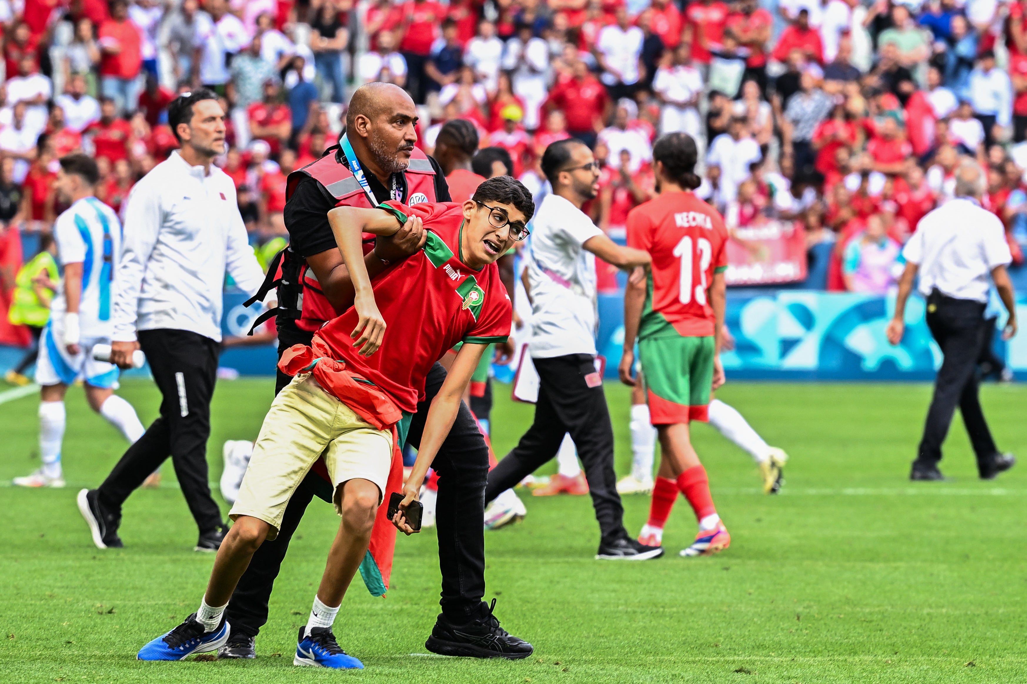 Fans storm pitch and throw bottles as Argentina v Morocco descends into chaos to kick off Olympics | The Independent