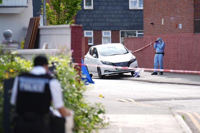 A forensic officer at the scene in Stellman Close in Hackney, London (PA)