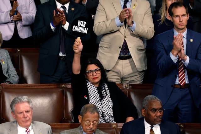 <p>WASHINGTON, DC - JULY 24:  Rep. Rashida Tlaib (D-MI) holds a sign that reads "War Criminal" as Israeli Prime Minister Benjamin Netanyahu addresses a joint meeting of Congress in the chamber of the House of Representatives.</p>