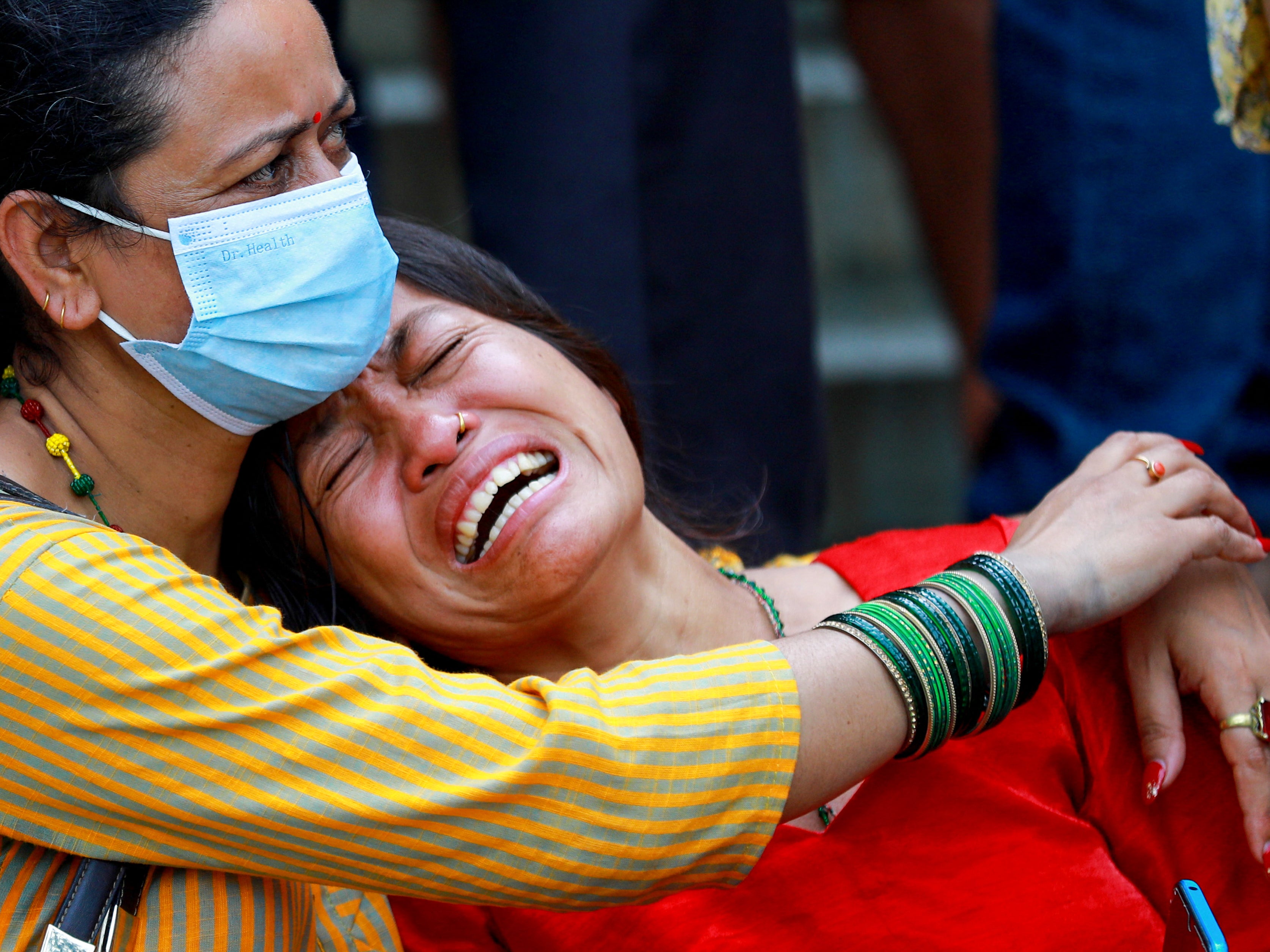 Relatives of the people who died in the Saurya Airlines plane crash mourn at a hospital in Kathmandu on 24 July 2024