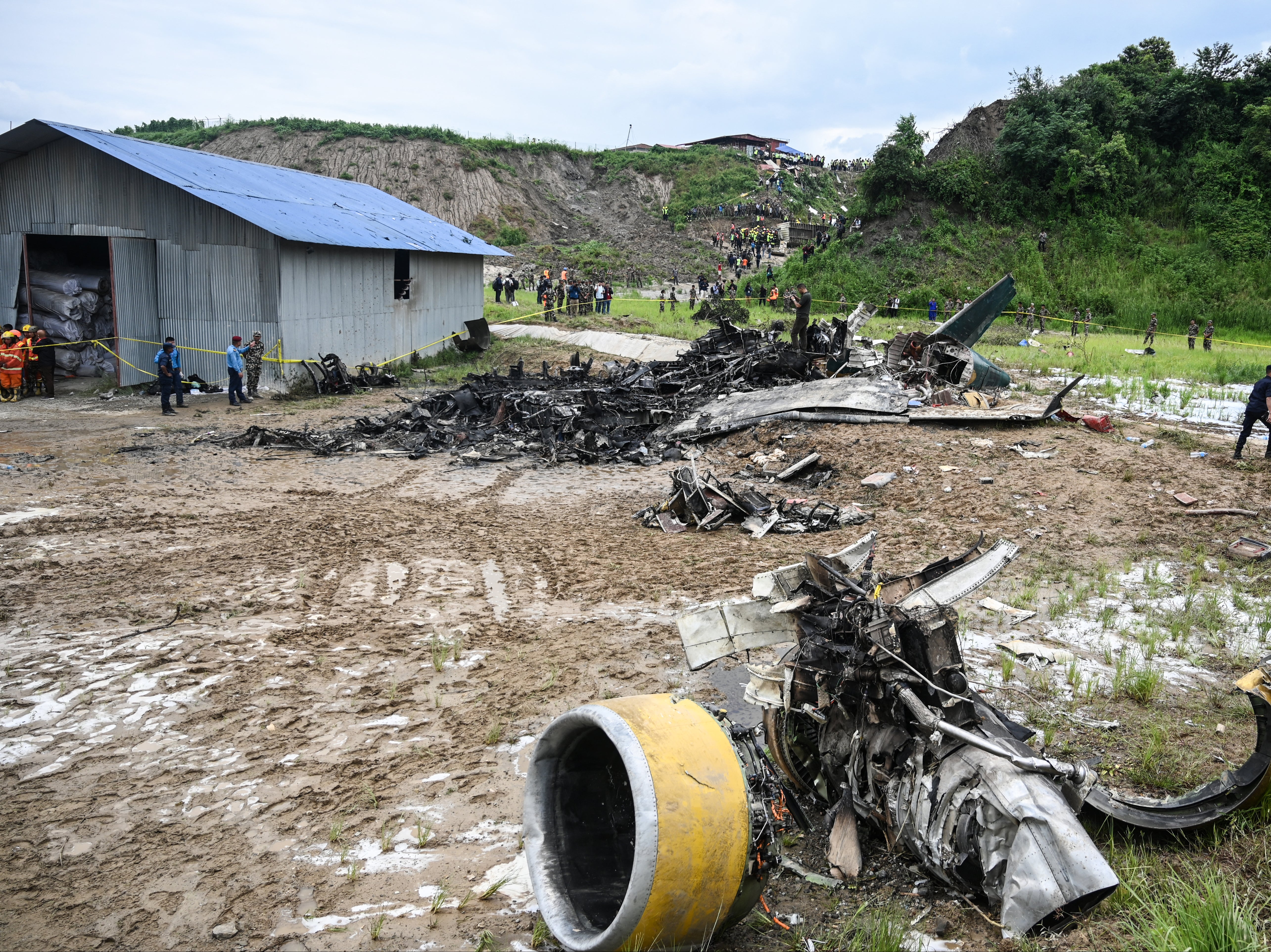 Rescue workers at the site of the Saurya Airlines plane crash at Kathmandu airport