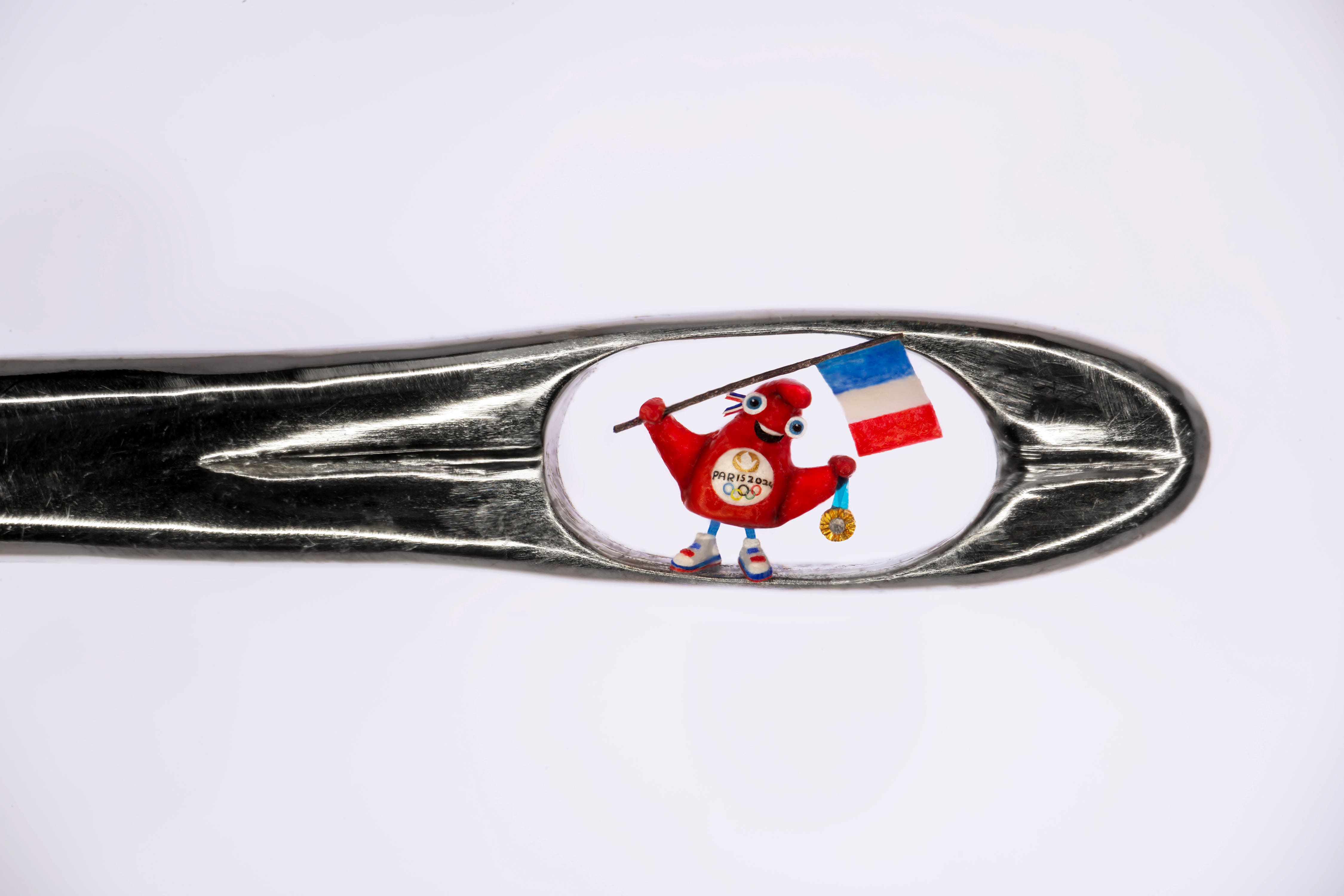 Renowned micro-sculptor Dr Willard Wigan created the world’s smallest Olympic mascot to celebrate the 2024 games in Paris (Willard Wigan/Paul Ward/PA)