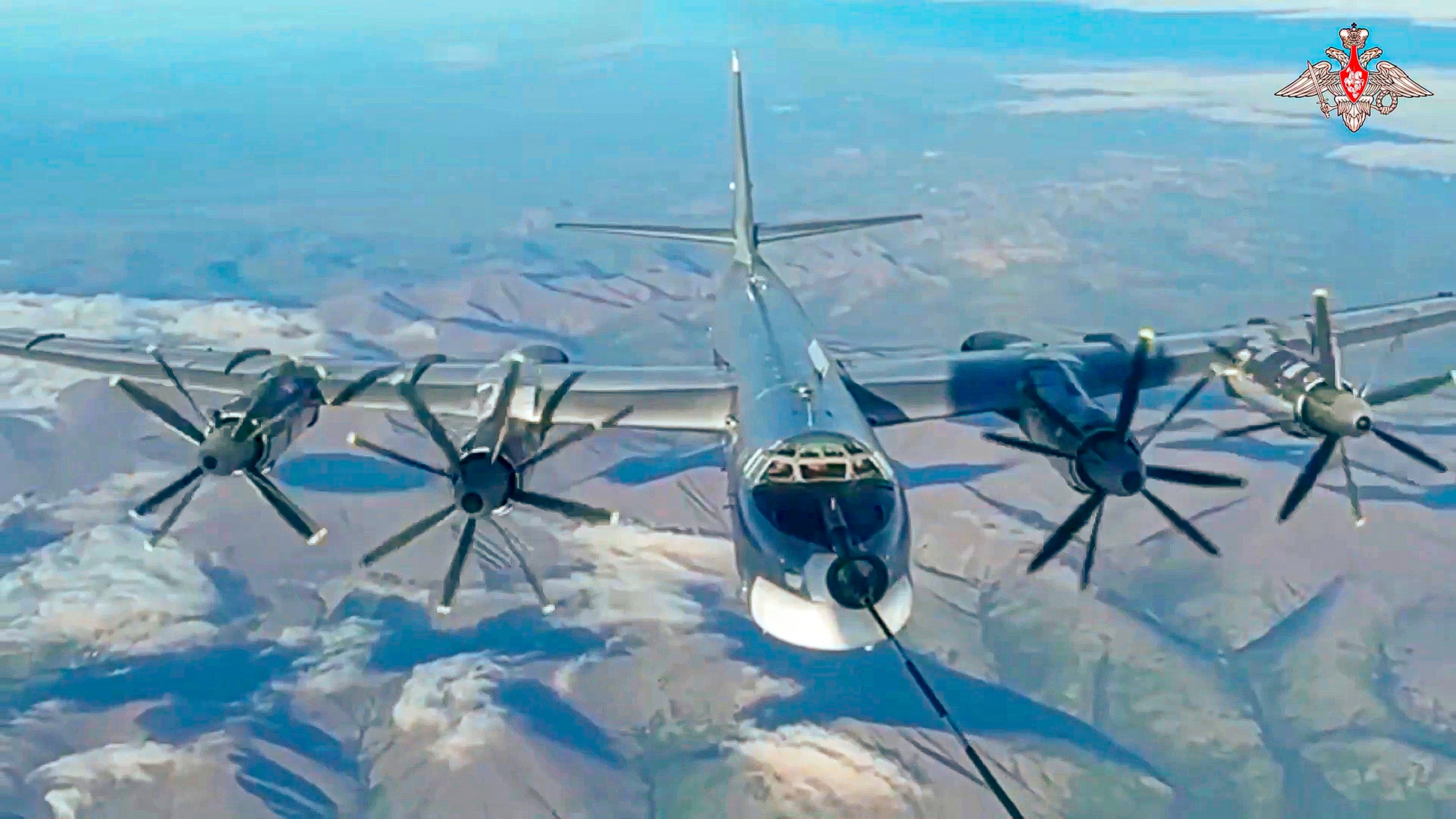 A Tu-95 strategic bomber of the Russian air force is refuelled in the air during a joint Russia-China air patrol