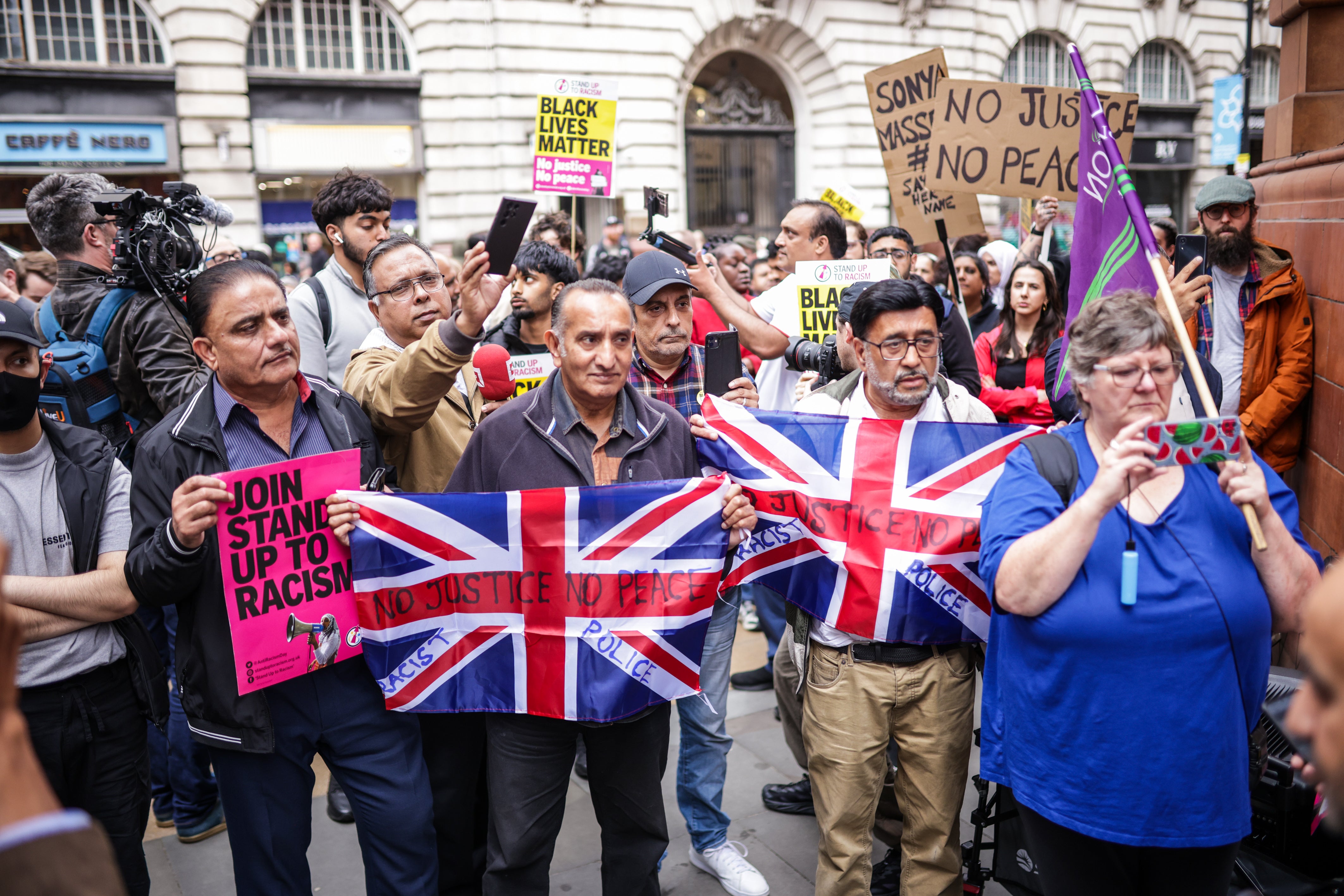 Protesters attend a Stand Up To Racism demonstration in Manchester on Thursday