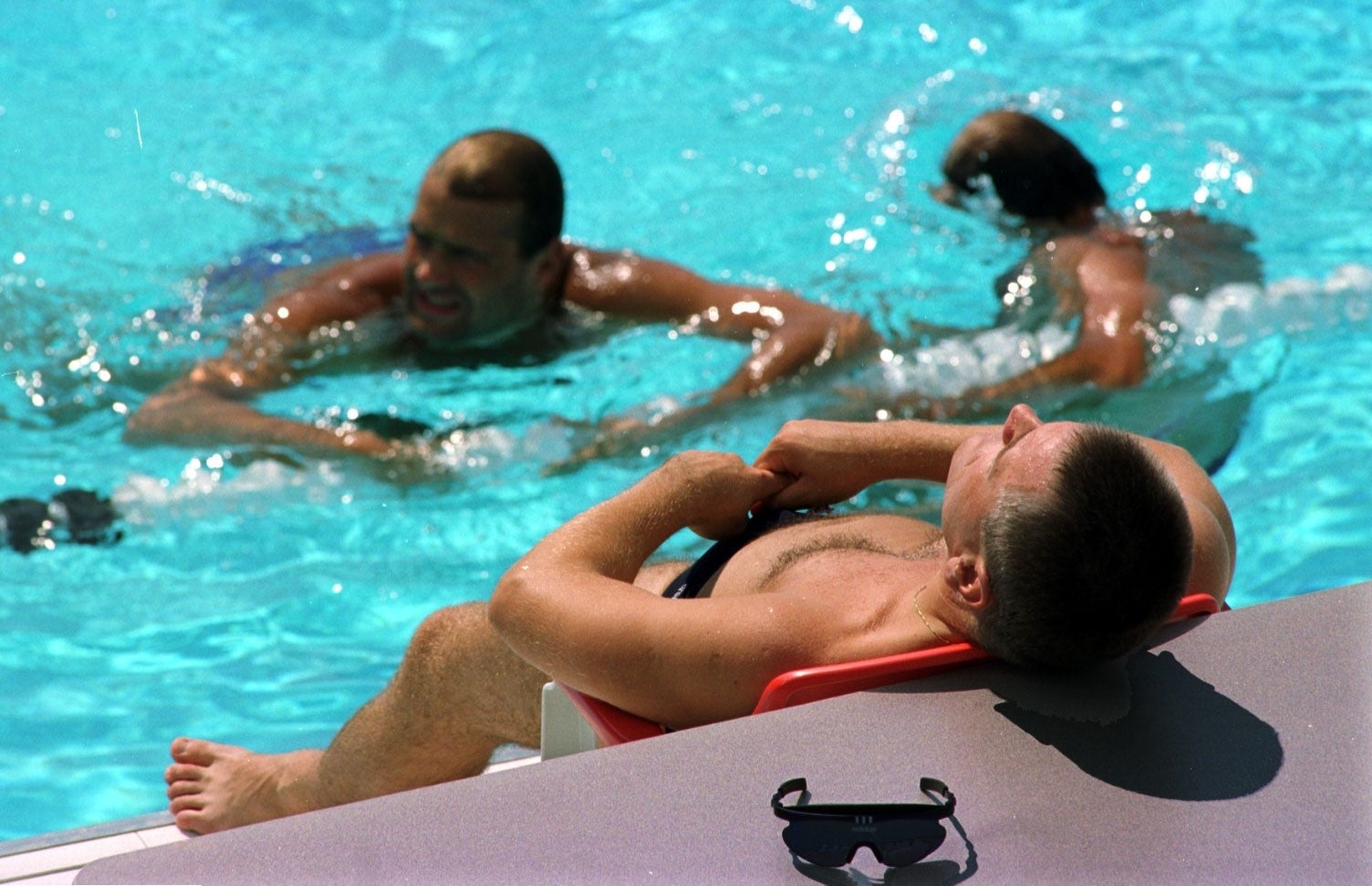 A water polo player rests during a training session at the Georgia Aquatic Center, 1996