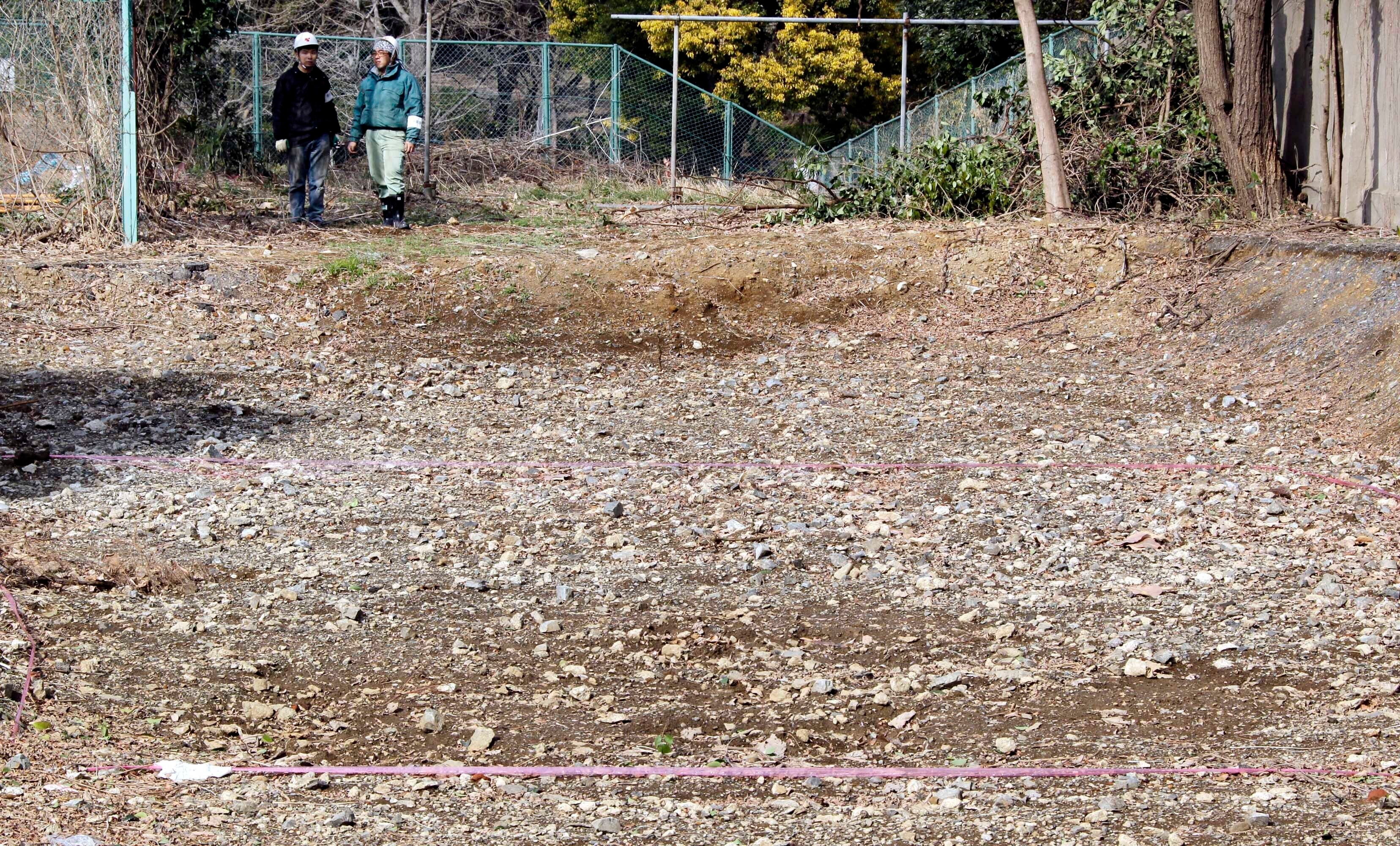 A pink tape is marked on the ground on Feb. 21, 2011, at the site of a former medical school in Tokyo