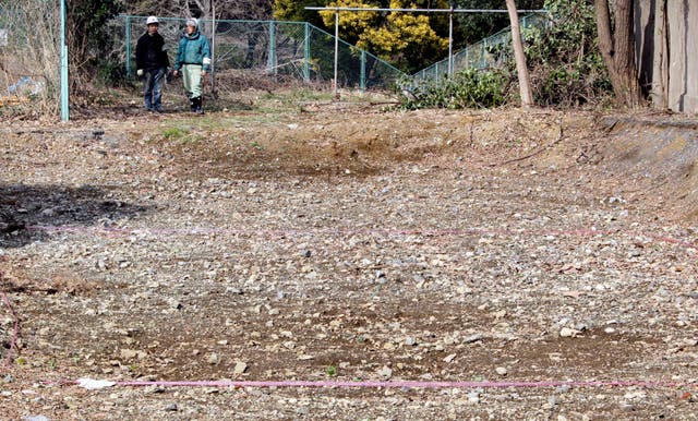 <p> A pink tape is marked on the ground on Feb. 21, 2011, at the site of a former medical school in Tokyo </p>