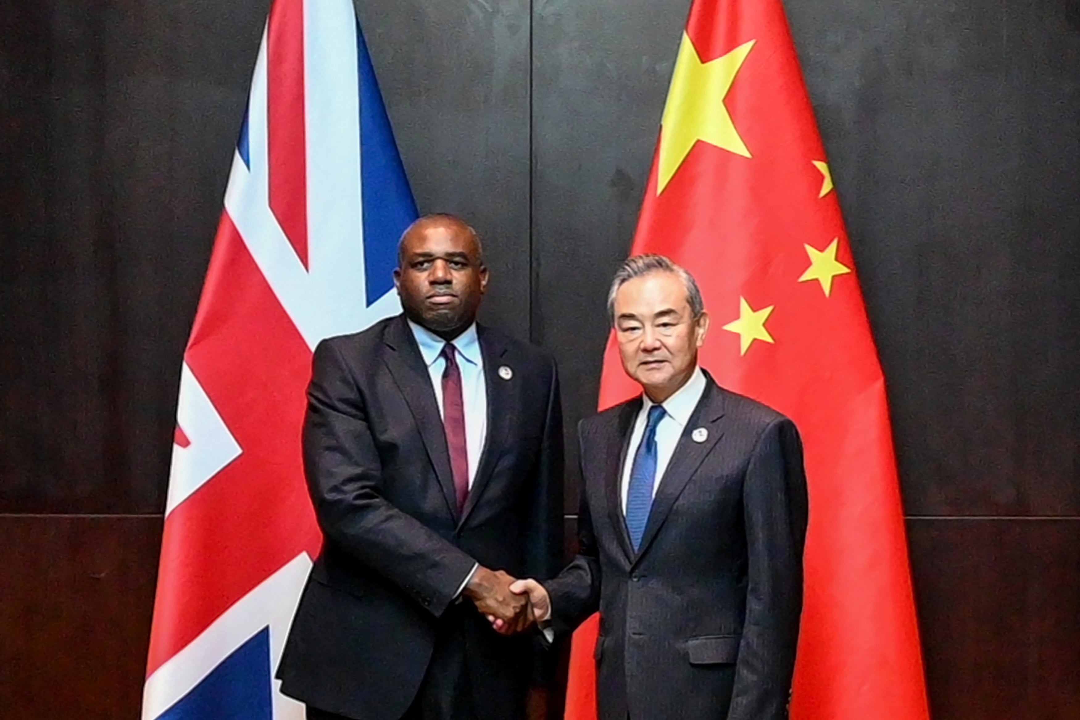 Foreign secretary David Lammy shakes hands with China’s foreign minister Wang Yi