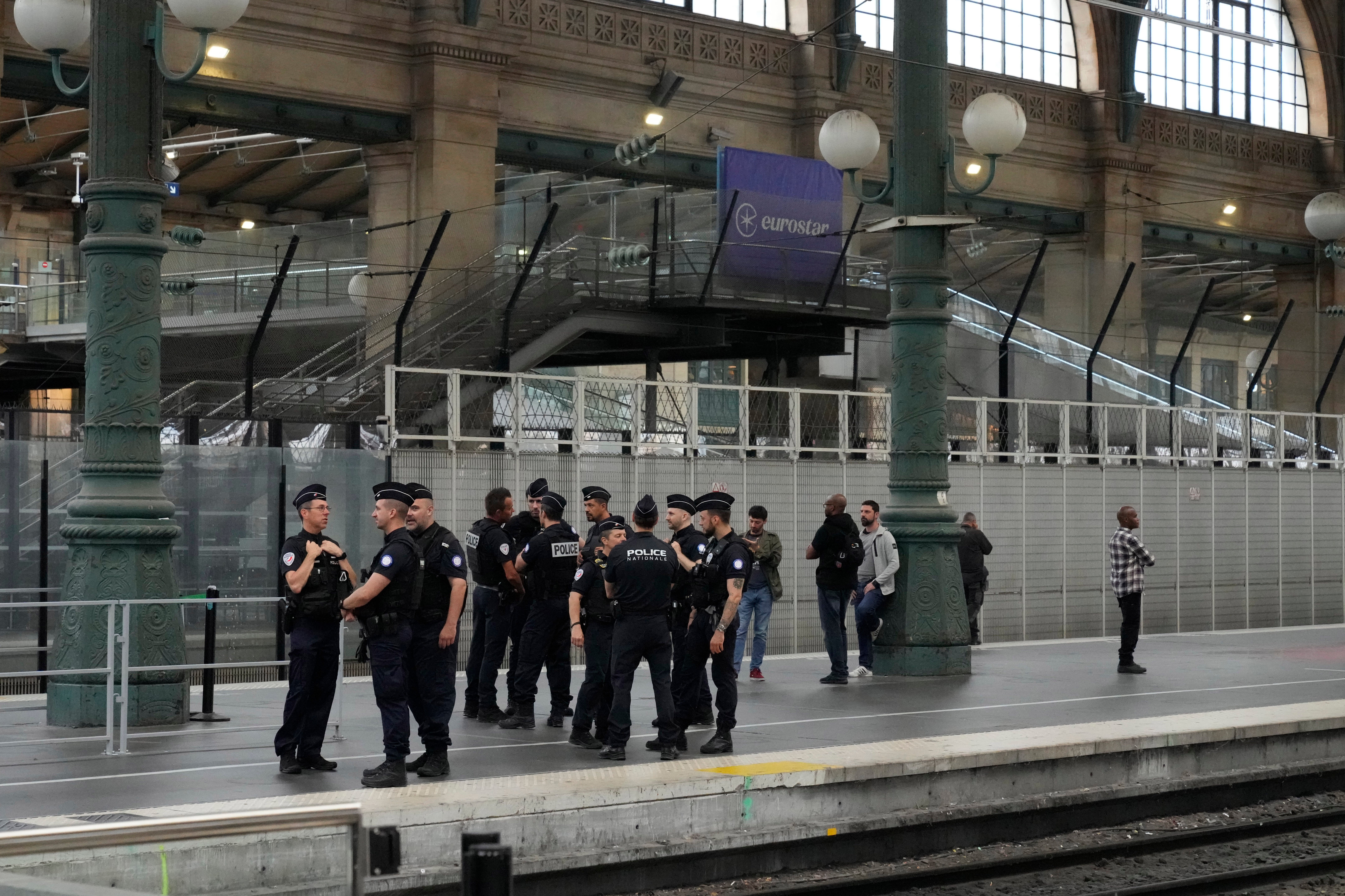 Police officers patrol inside the Gare du Nord train station following a coordinated ‘arson attack’ on France’s rail network