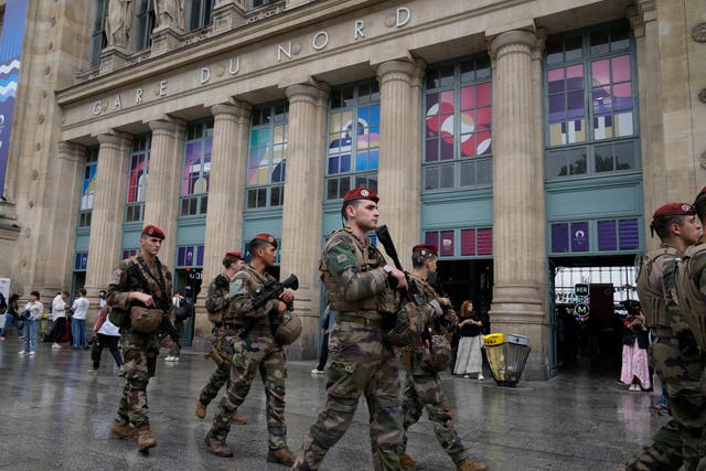 <p>Soldiers patrol outside Gare du Nord train station before the 2024 Summer Olympics opening ceremony in Paris on Friday</p>