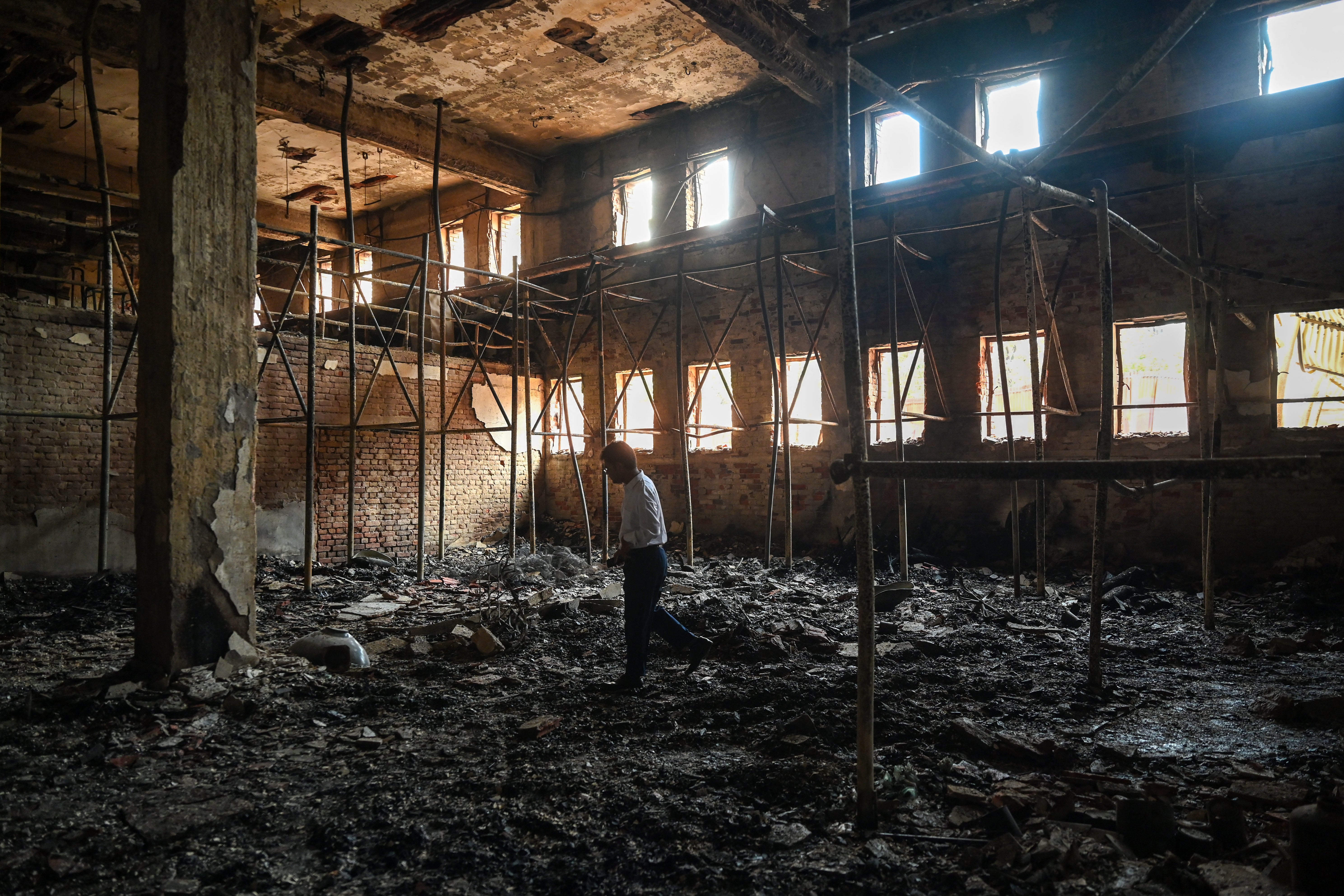 The charred remains of state broadcaster Bangladesh Television is pictured after students set it on fire during the anti-quota protest, in Dhaka on 24 July 2024