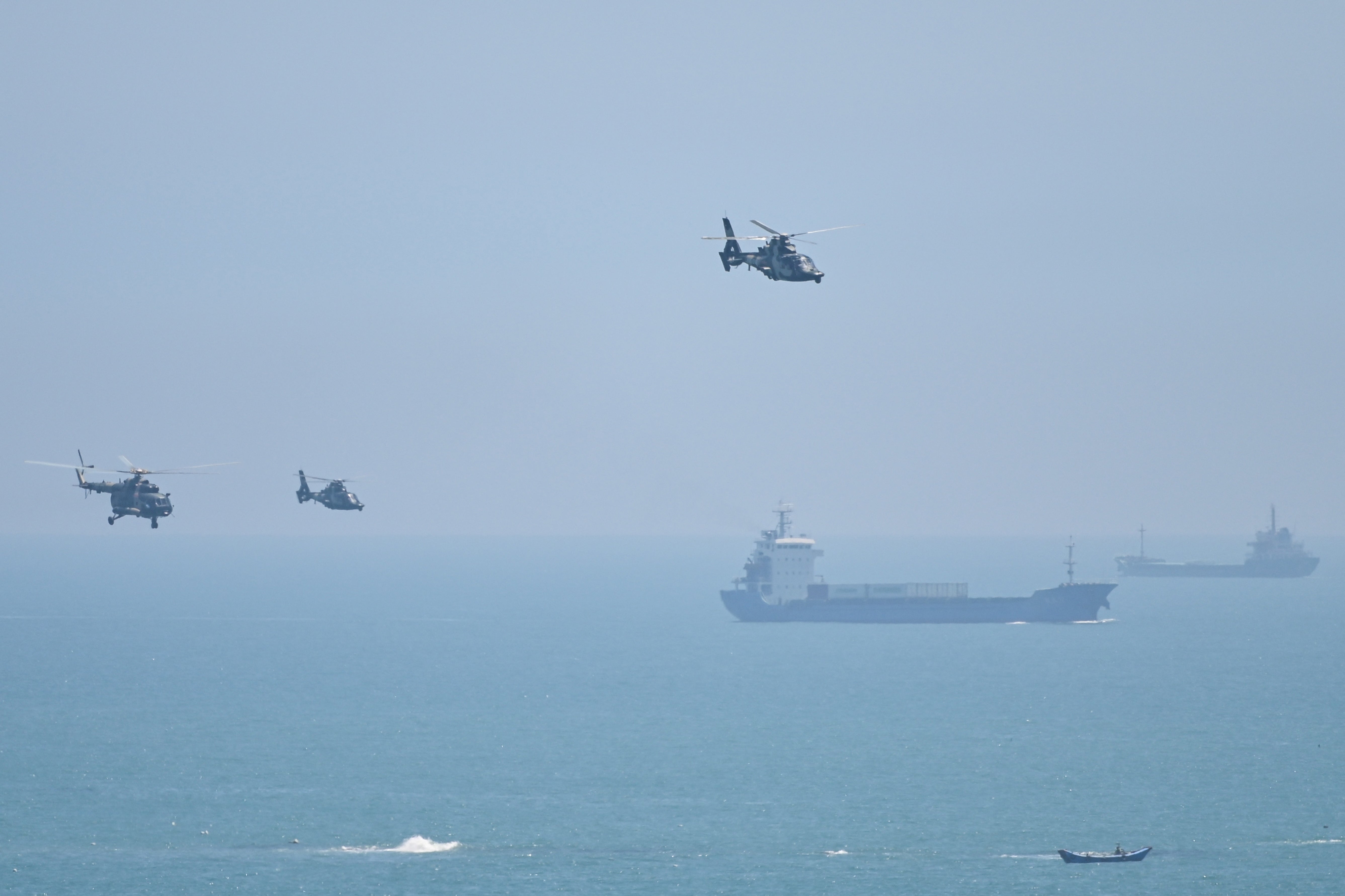 Chinese military helicopters fly past Pingtan island, one of mainland China’s closest points to Taiwan