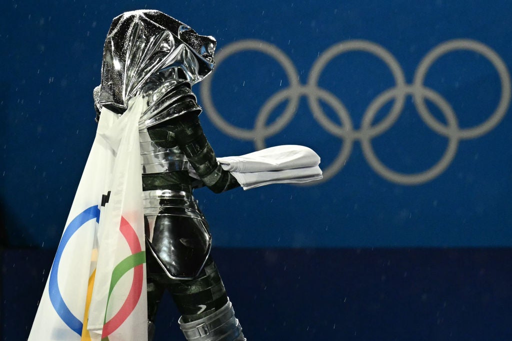 Floriane Issert, a Gendarmerie non-commissioned officer of the National Gendarmerie, carries the Olympic flag