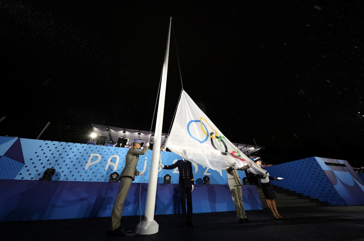 Olympic flag raised upside down at end of rain-soaked opening ceremony