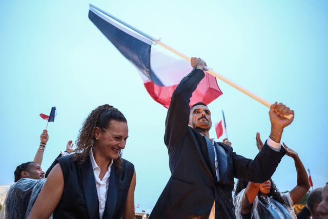 <p>France’s flag bearer Florent Manaudou (R), France’s flag bearer Melina Robert-Michon</p>